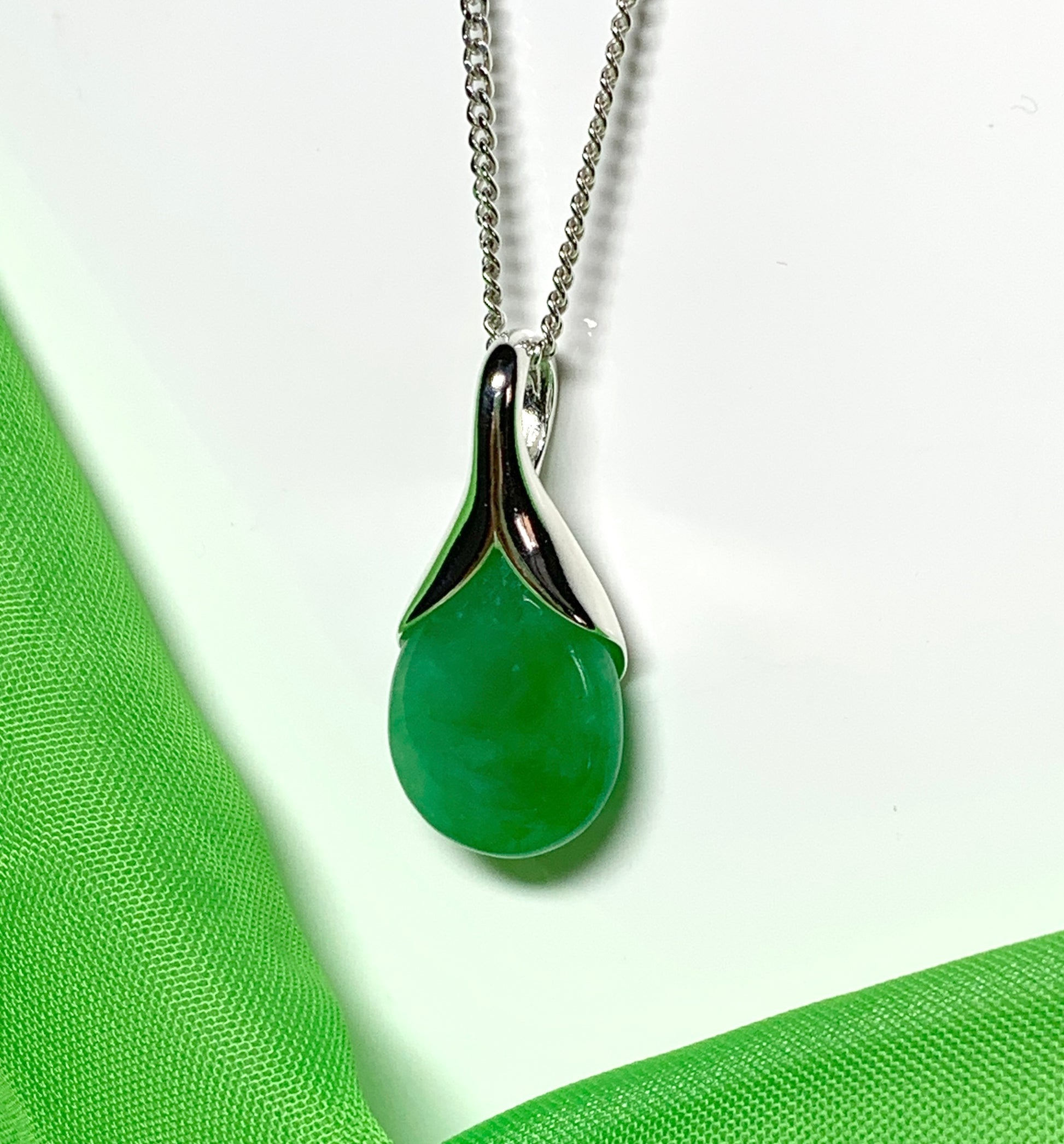 Real green jade necklace in a tear drop or pear shaped sterling silver pendant