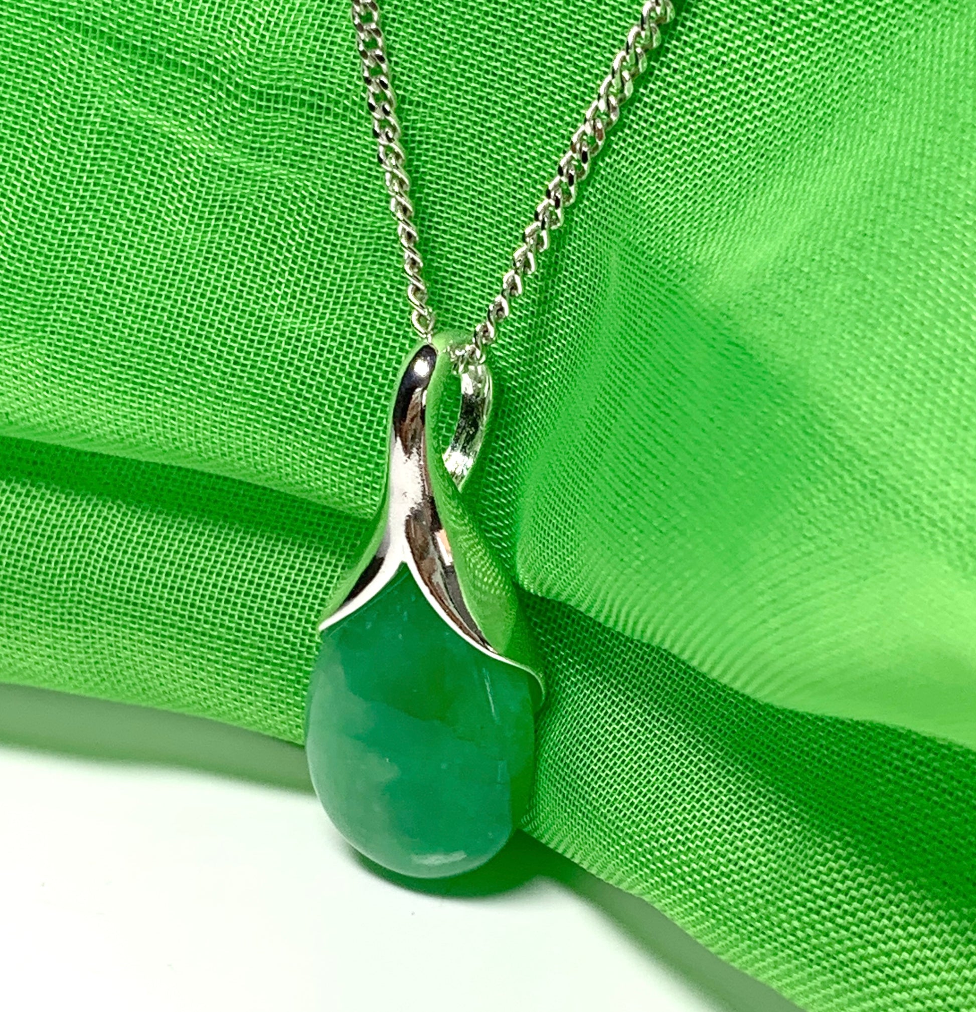 Real green jade necklace in a tear drop or pear shaped sterling silver pendant