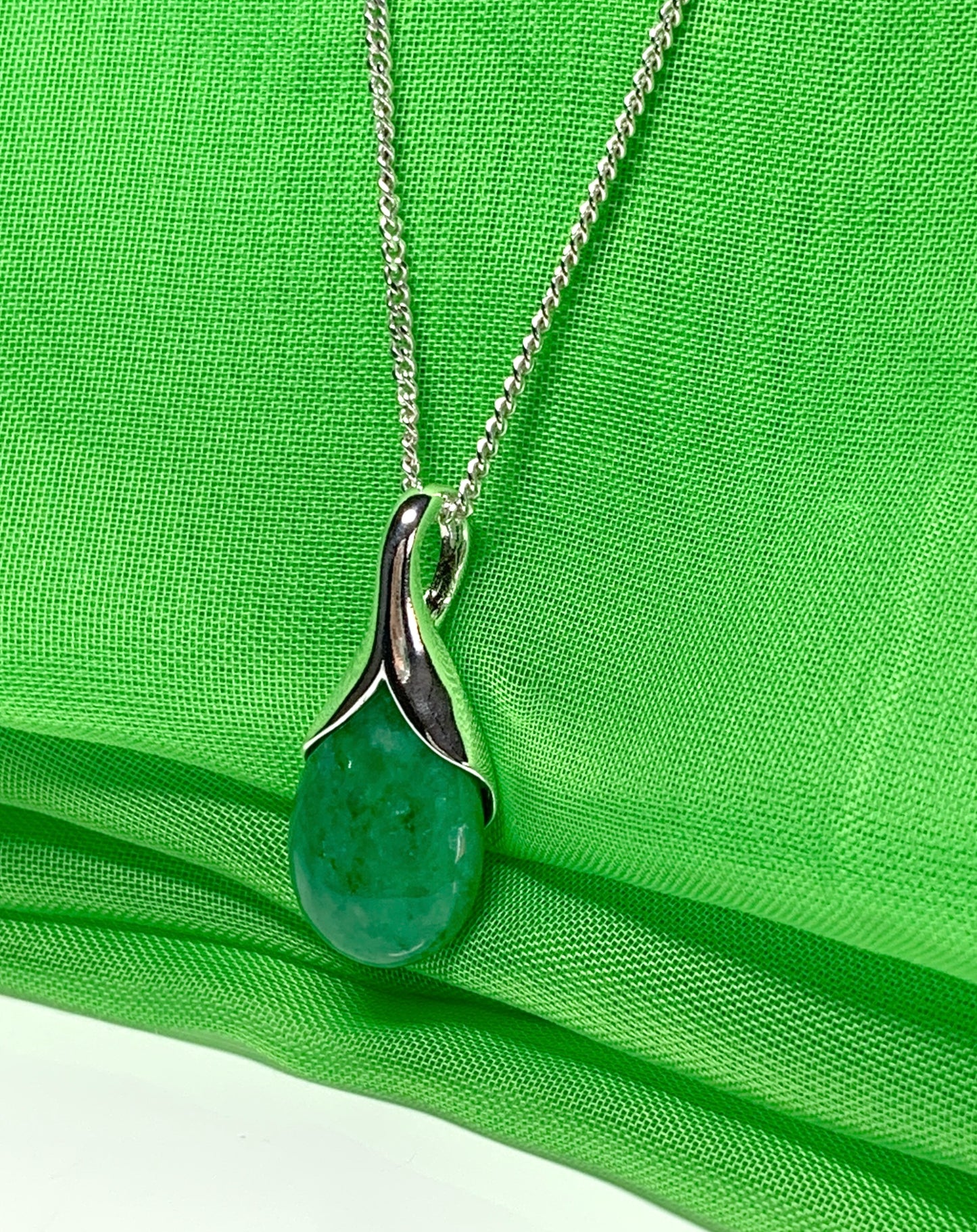 Real green jade necklace in a pear or tear drop shaped sterling silver pendant