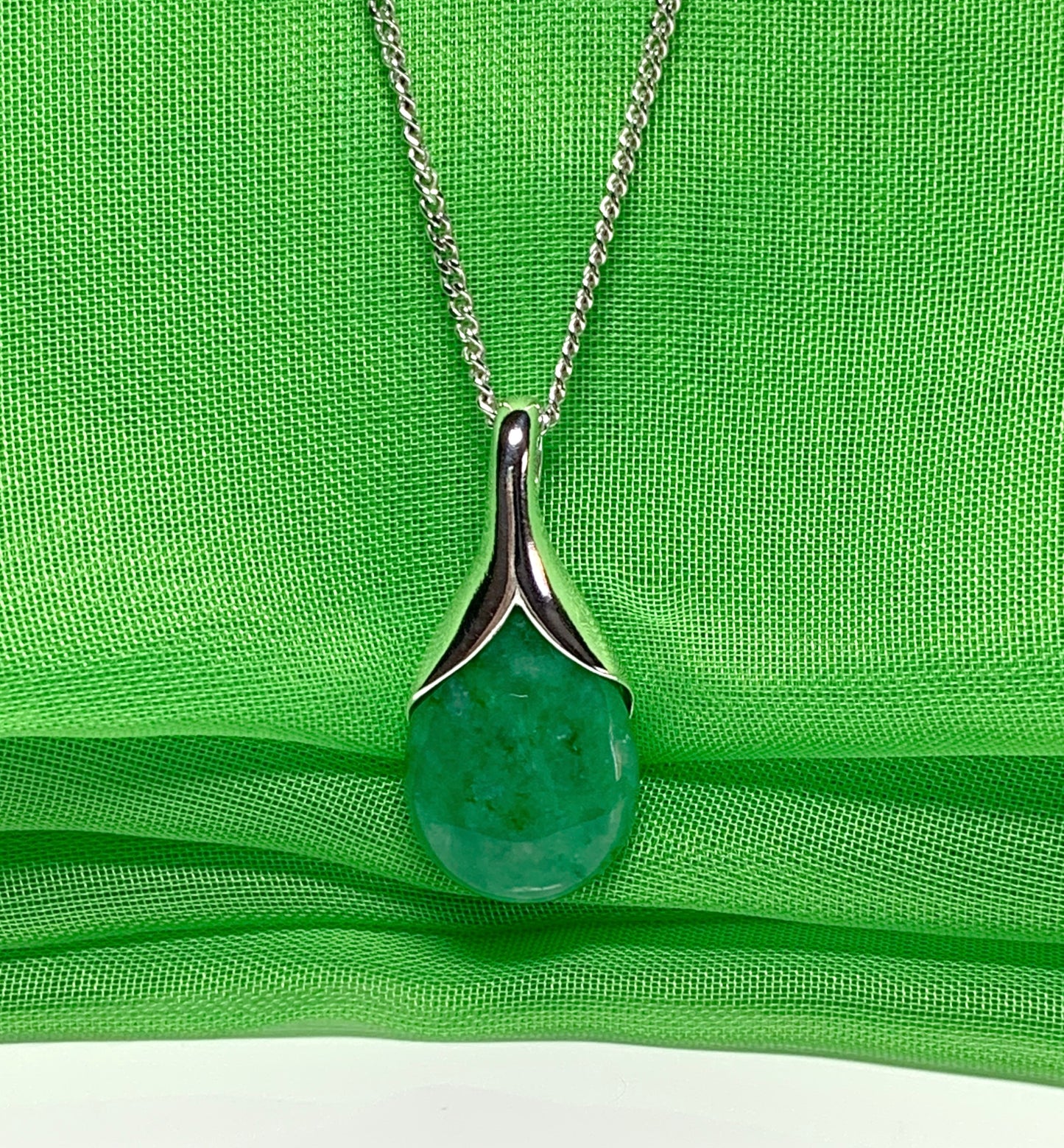 Real green jade necklace in a pear or tear drop shaped sterling silver pendant