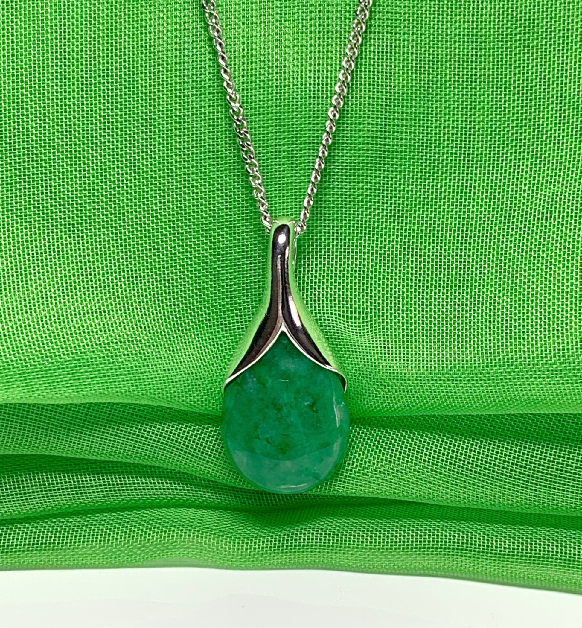 Real green jade necklace in a pear or tear drop shaped sterling silver pendant