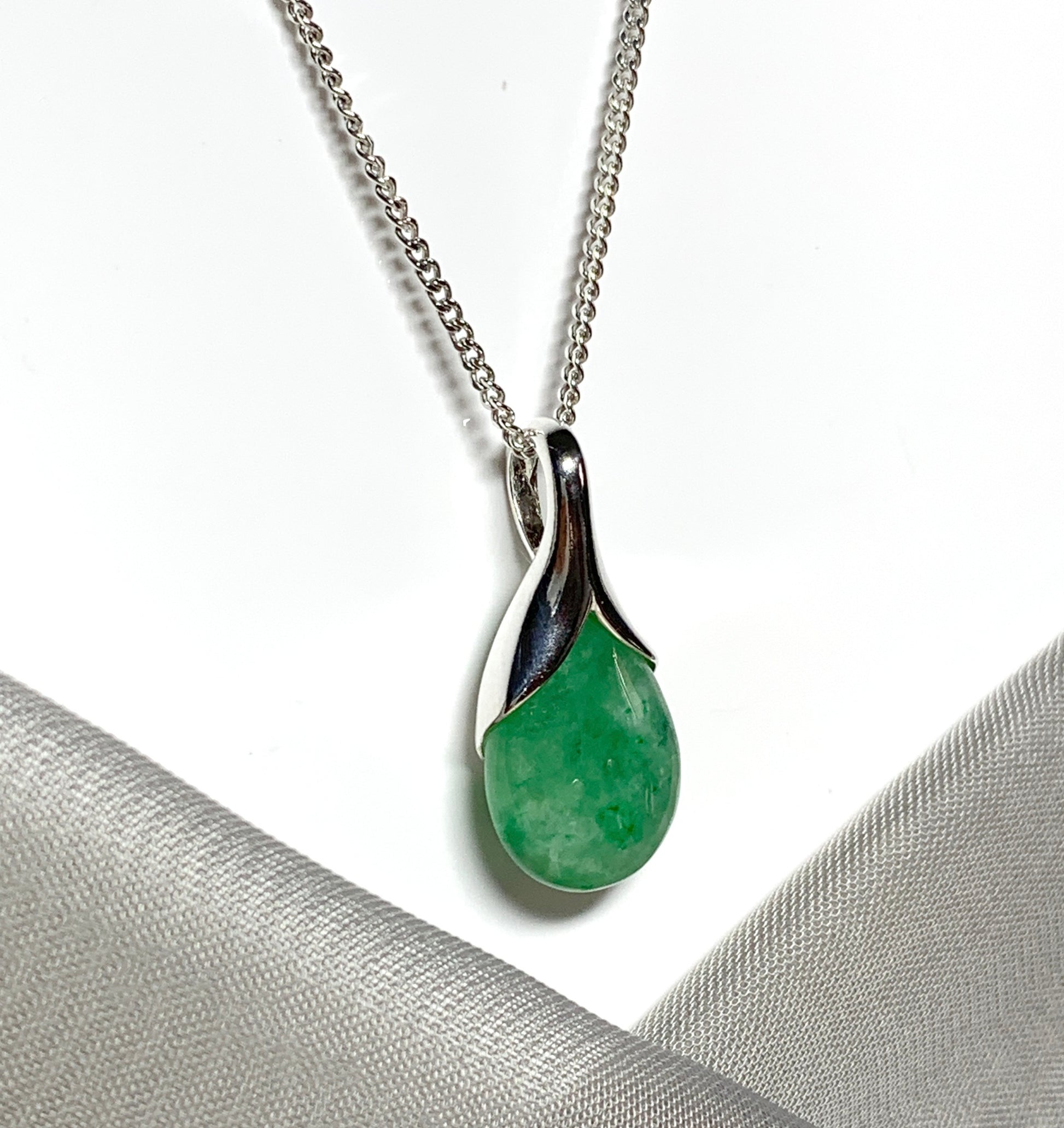 Real green jade pendant necklace in a teardrop shaped or pear shaped