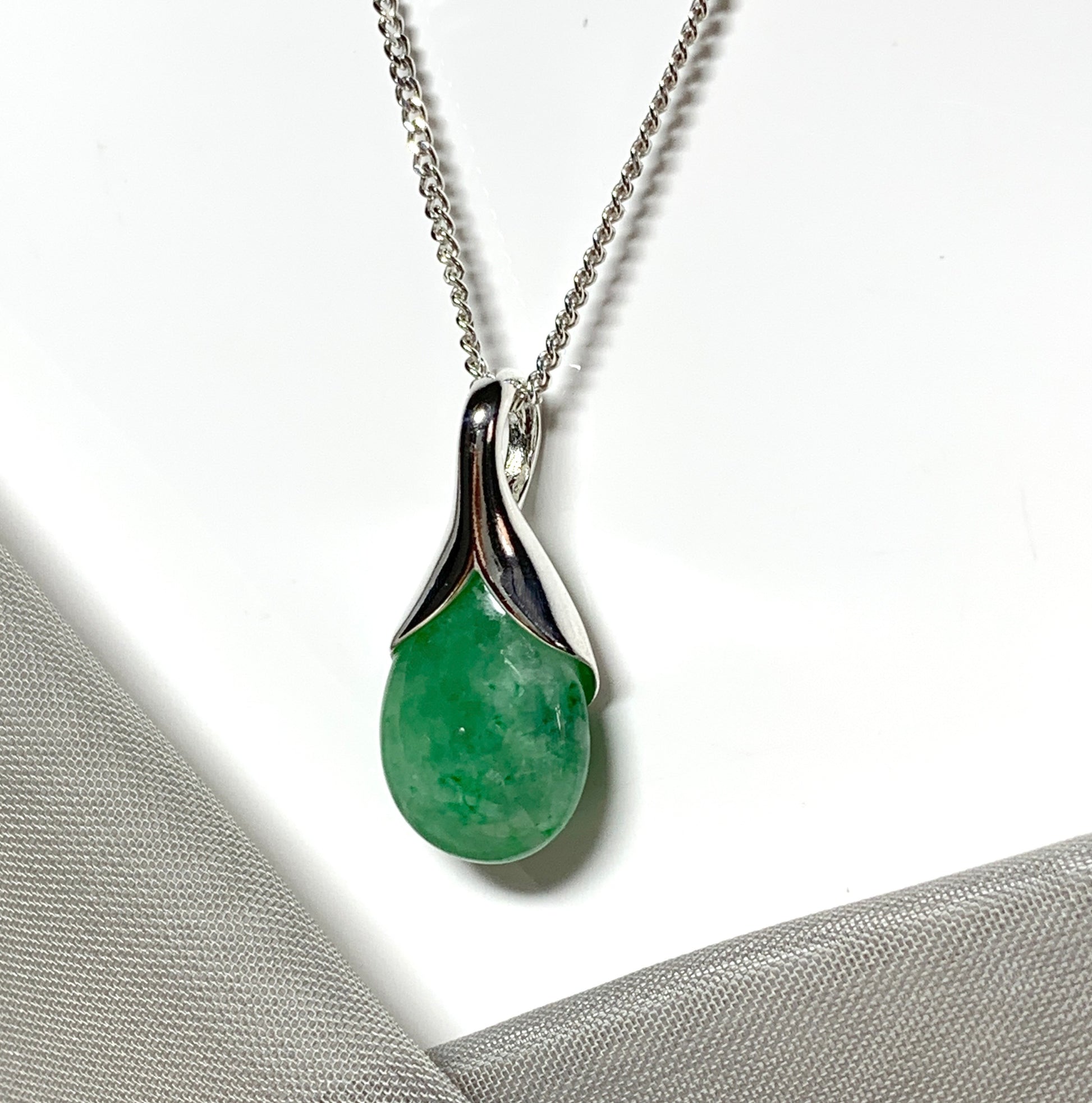 Real green jade pendant necklace in a teardrop shaped or pear shaped