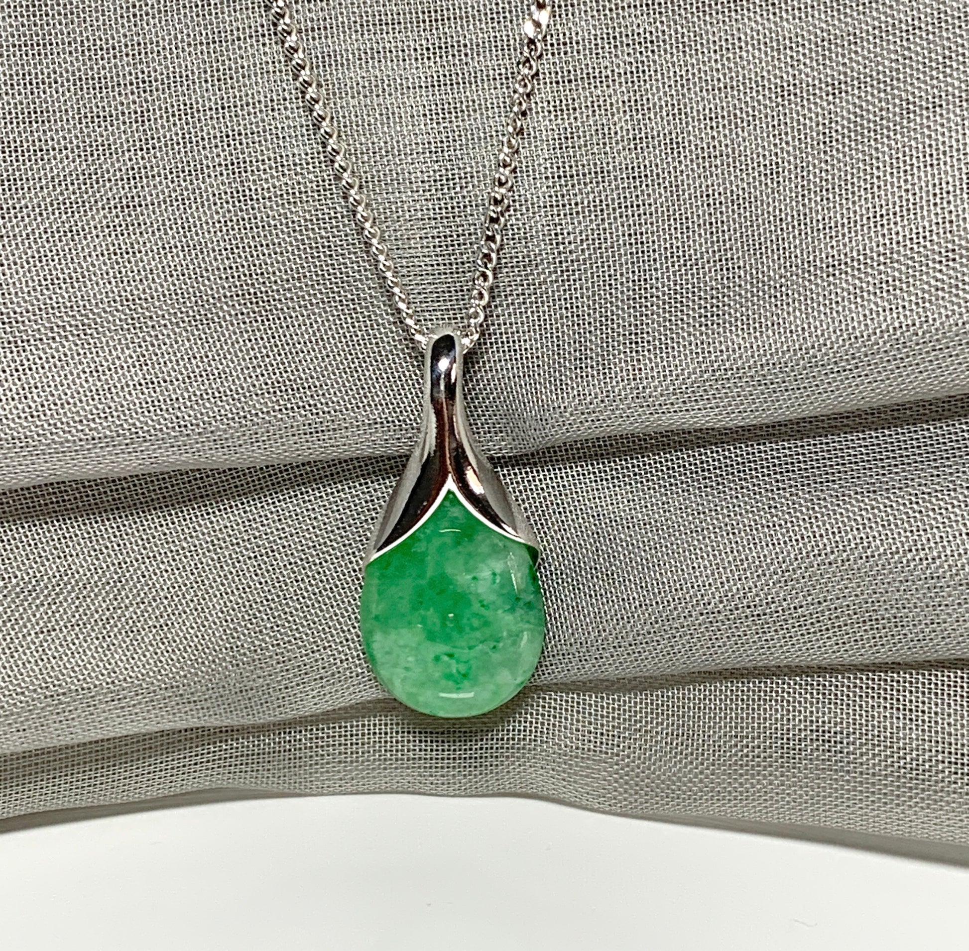 Real green jade pendant necklace in a teardrop shaped or pear shaped