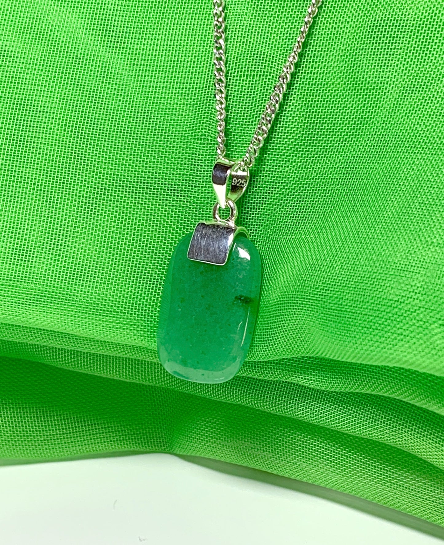 A real green jade sterling silver cushion shaped pendant