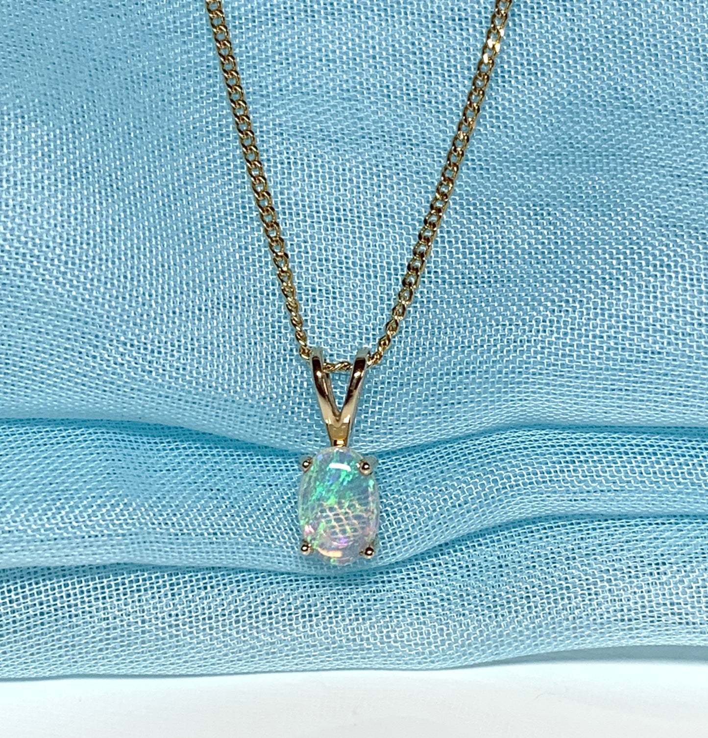 Real opal pendant oval cut yellow gold