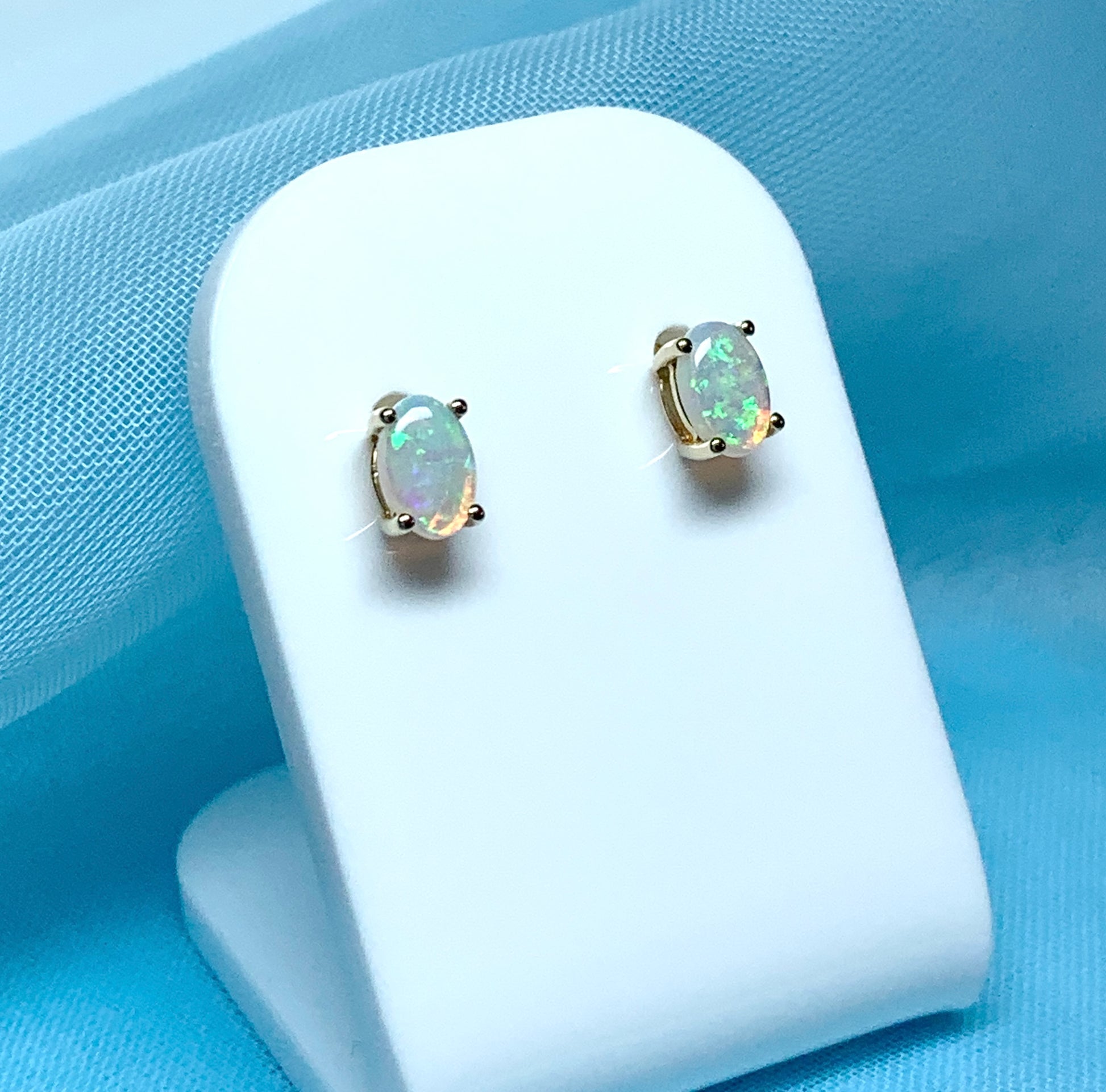 Real opal yellow gold claw set oval stud earrings