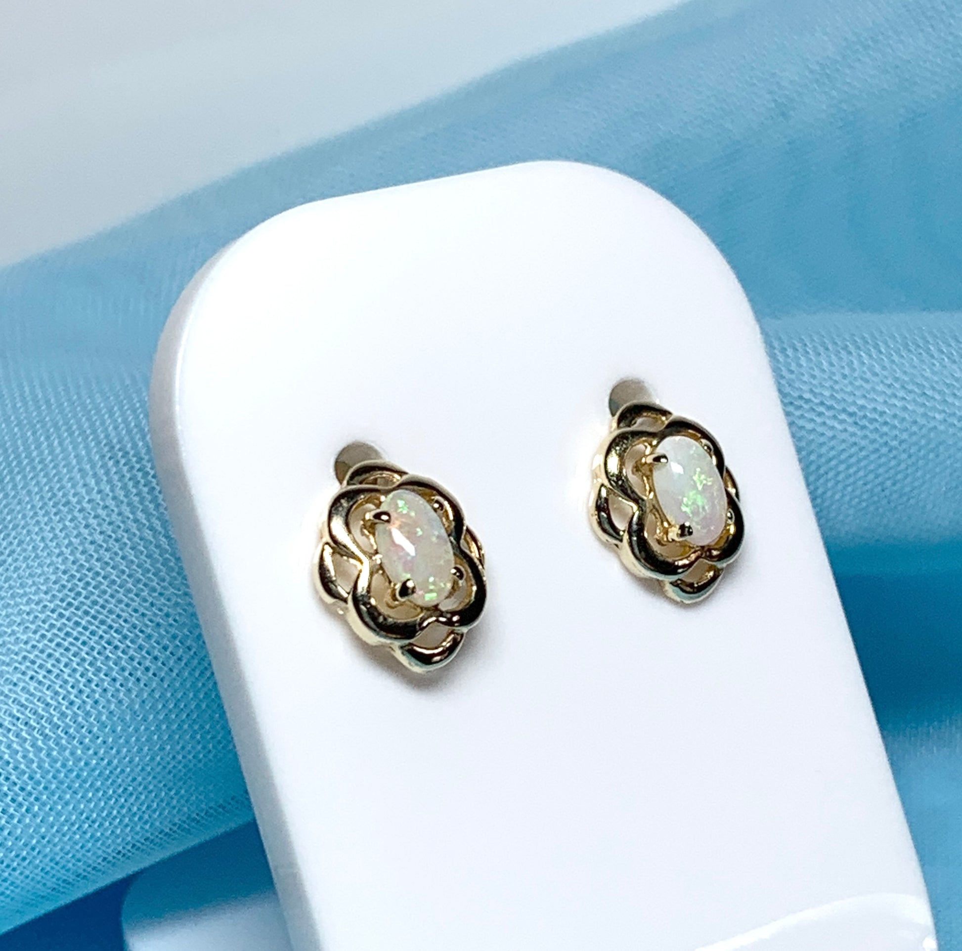 Opal yellow gold emerald stud earrings oval shaped scroll design