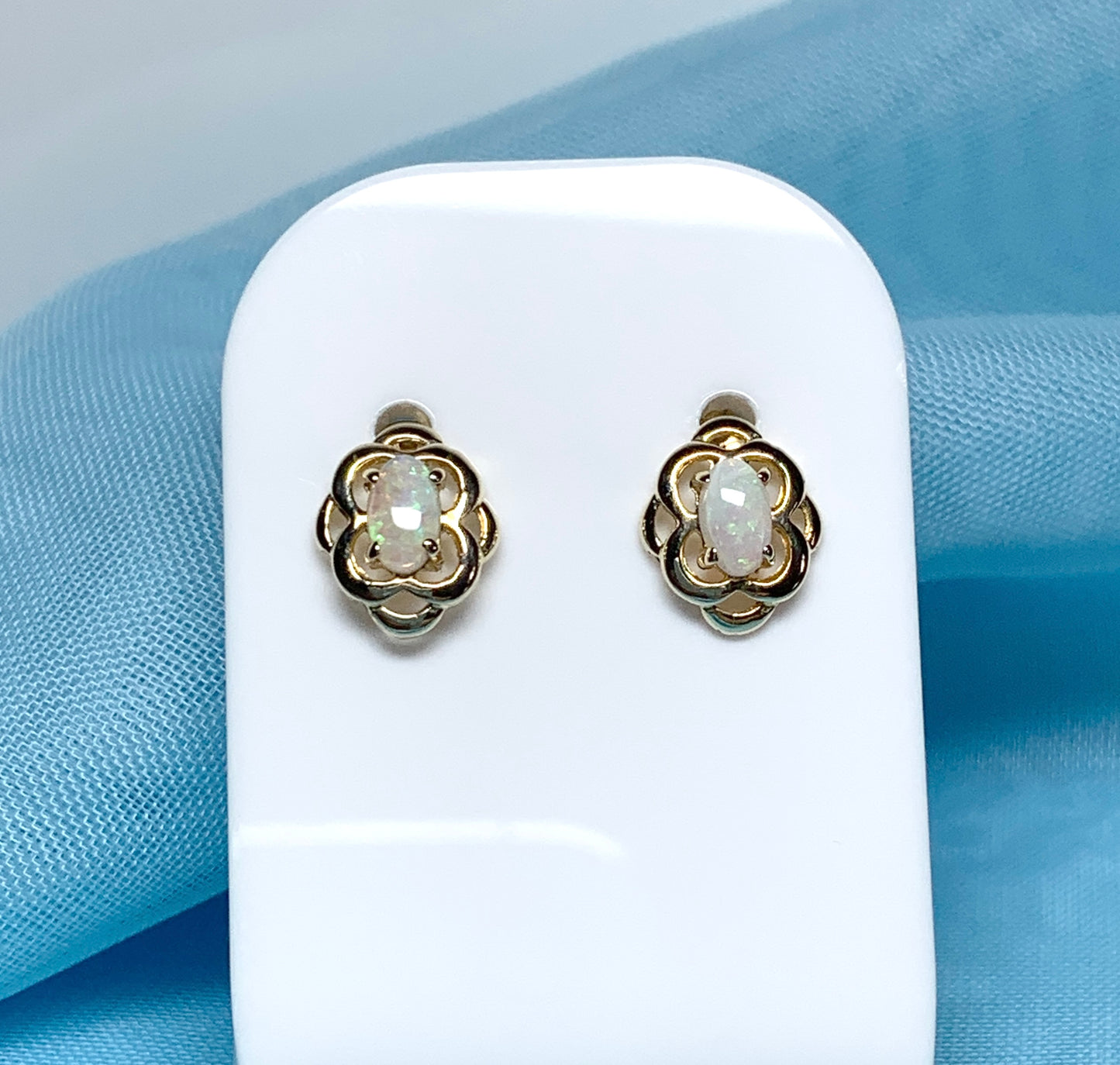 Opal yellow gold emerald stud earrings oval shaped scroll design