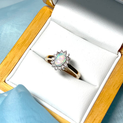 Real oval opal and diamond cluster yellow gold ring