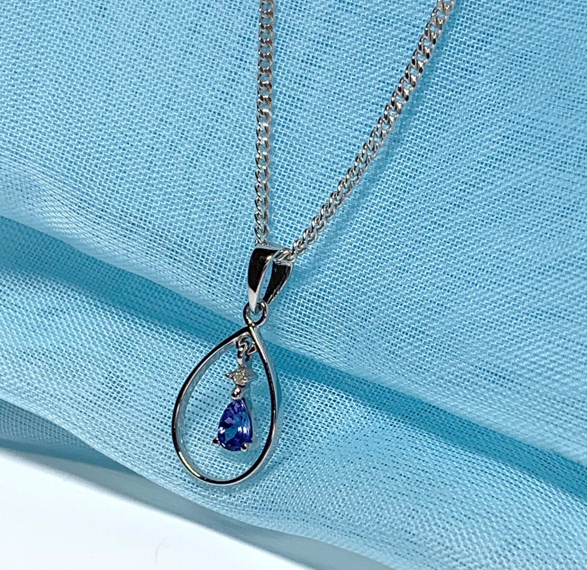 Real tanzanite and diamond necklace white gold open pear shaped