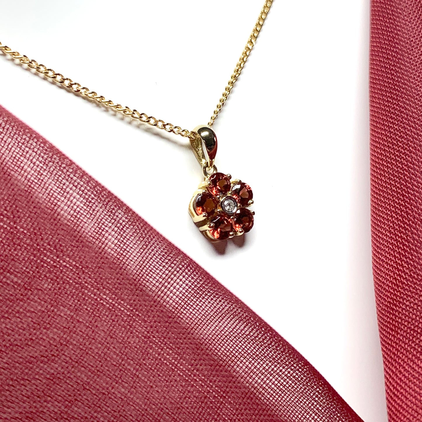 Red brown garnet and diamond yellow gold daisy cluster necklace pendant