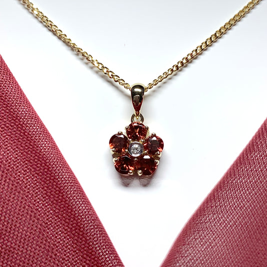 Red brown garnet and diamond yellow gold daisy cluster necklace pendant