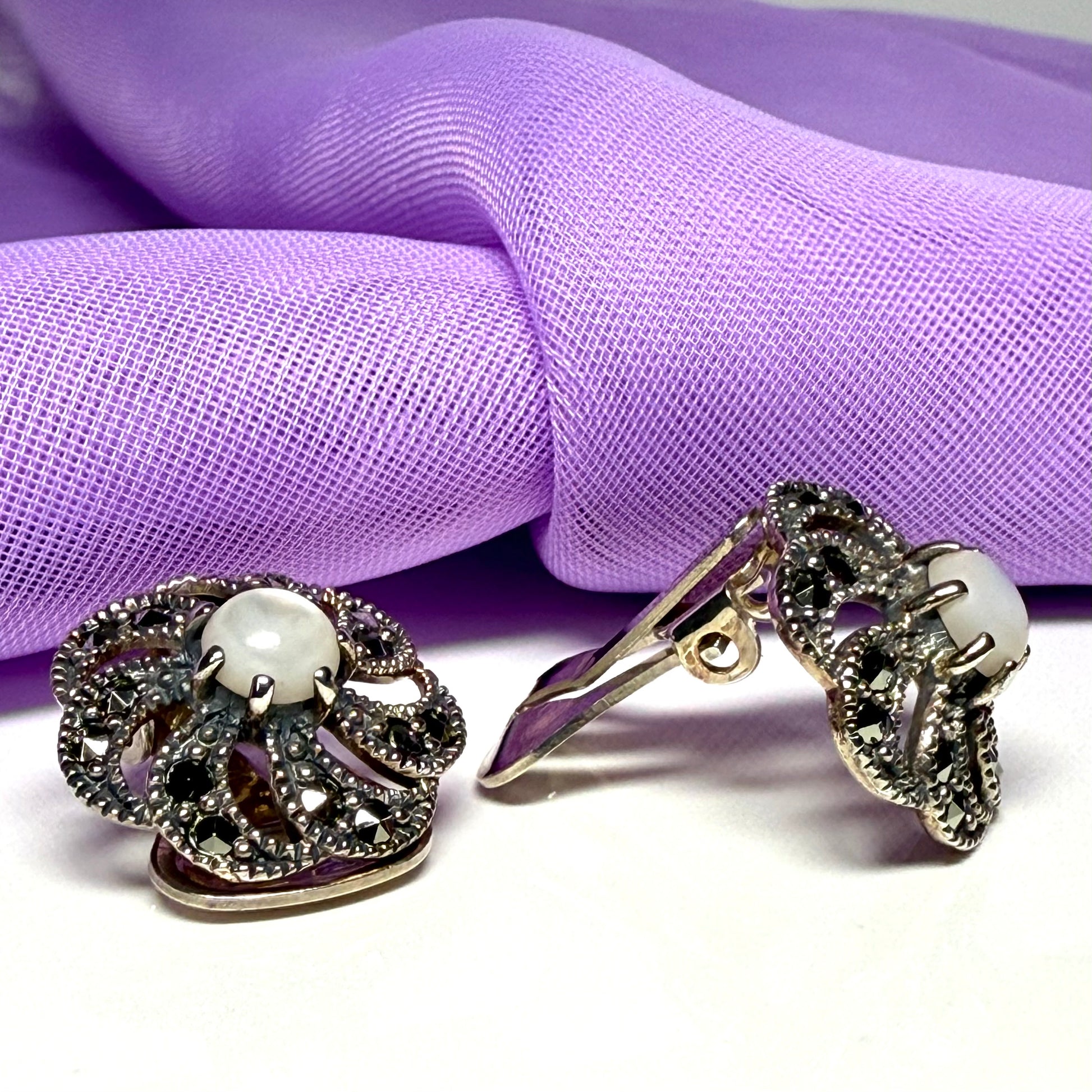 Round clip on earrings with marcasite and mother of pearl and sterling silver