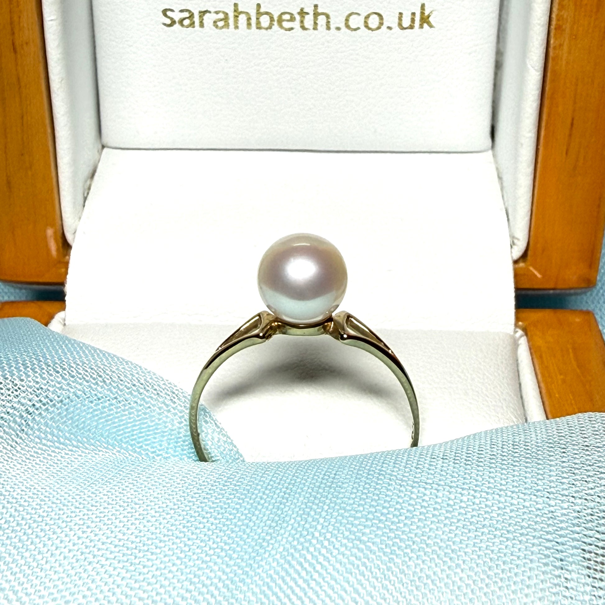 Round real cultured single pearl ring with an open shoulder design yellow gold