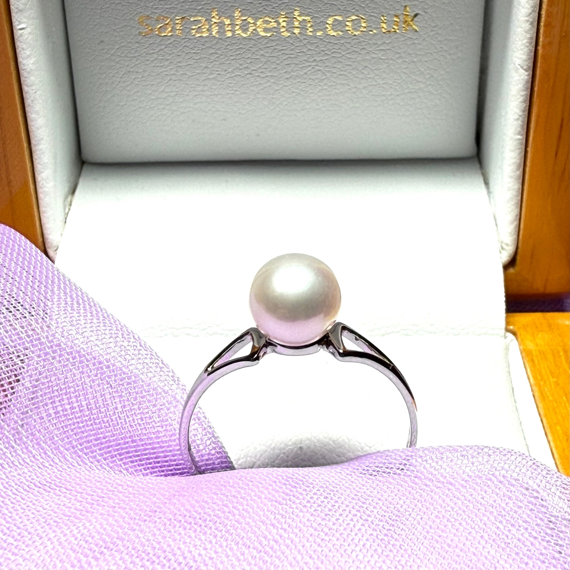 Round real cultured single pearl ring with an open shoulder design white gold