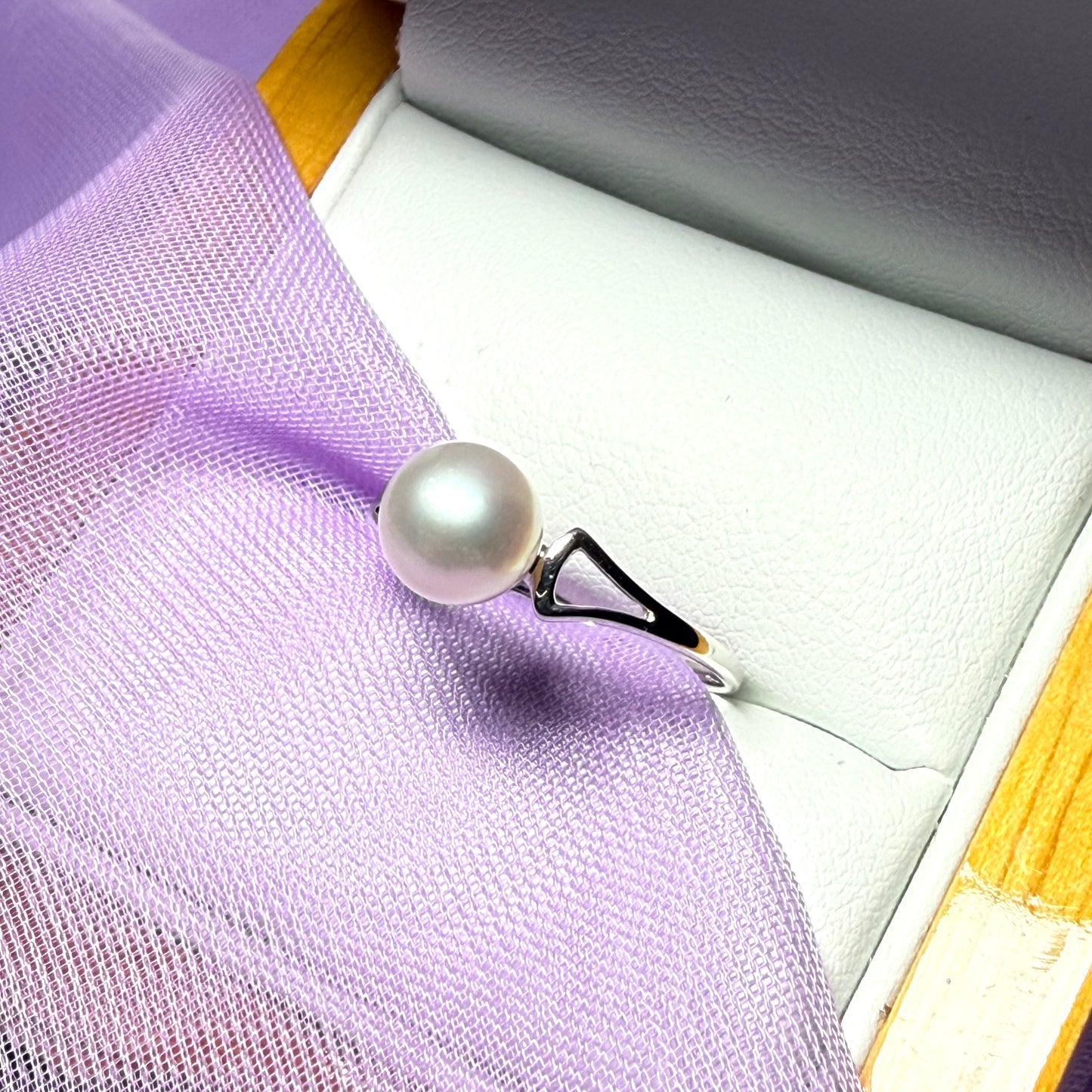 Round real cultured single pearl ring with an open shoulder design white gold