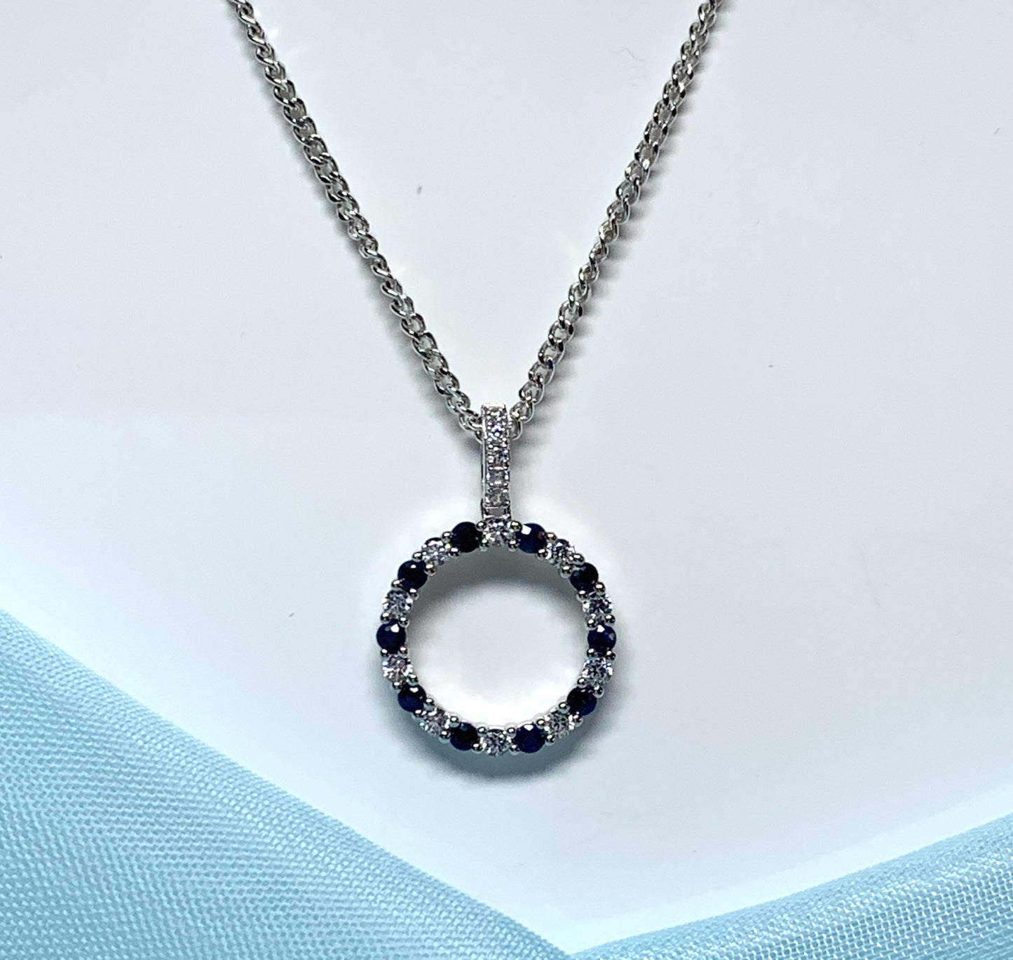 Round blue sapphire and cubic zirconia sterling silver necklace pendent