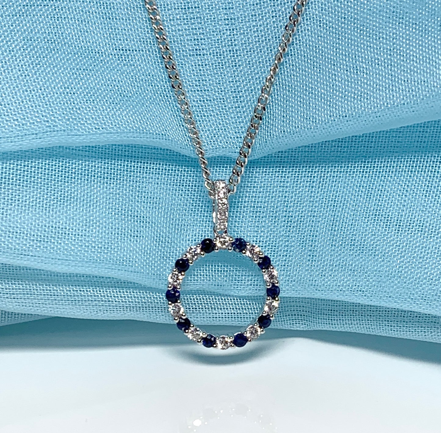 Round blue sapphire and cubic zirconia sterling silver necklace pendent