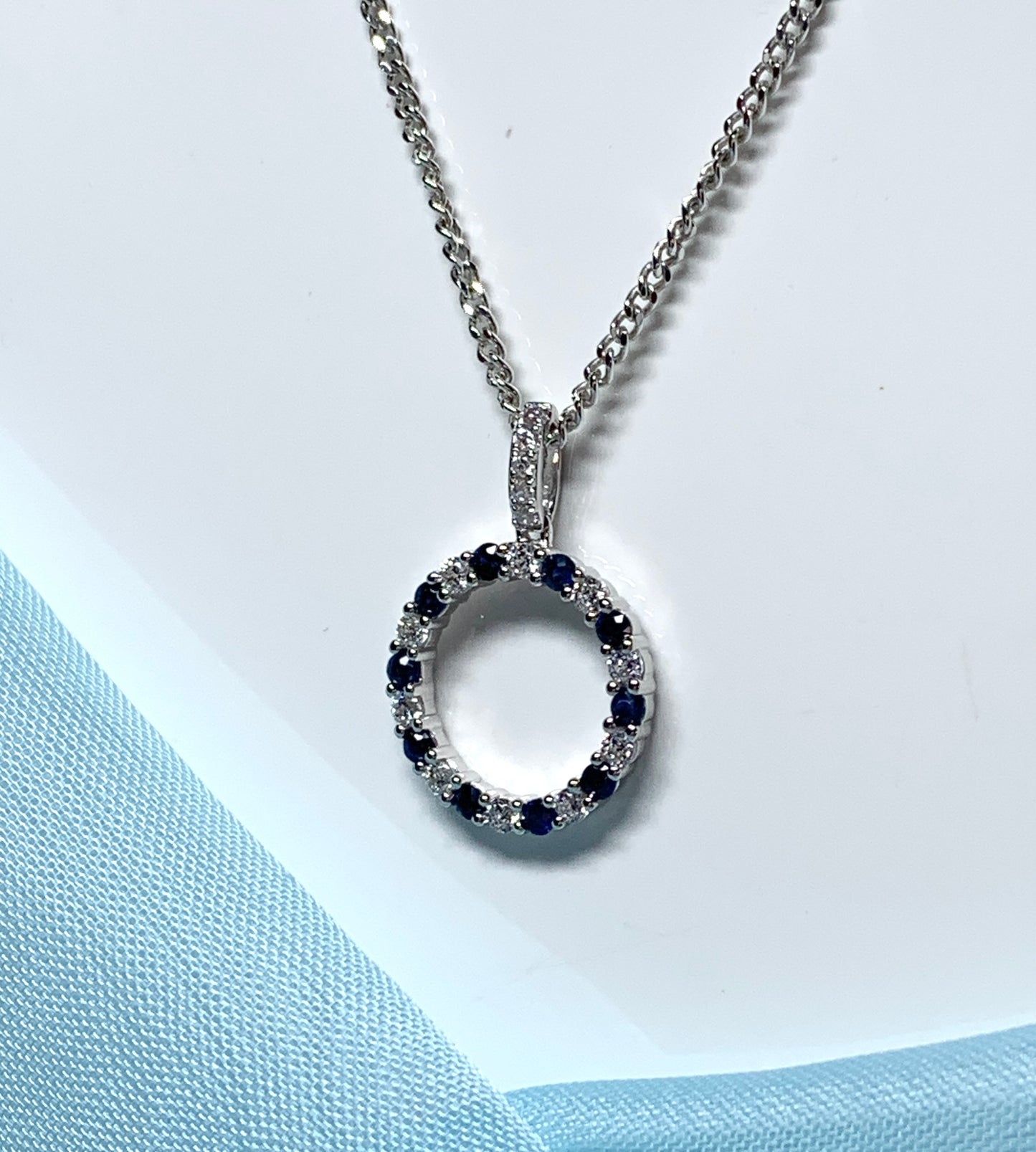 Round blue sapphire and cubic zirconia sterling silver necklace pendent