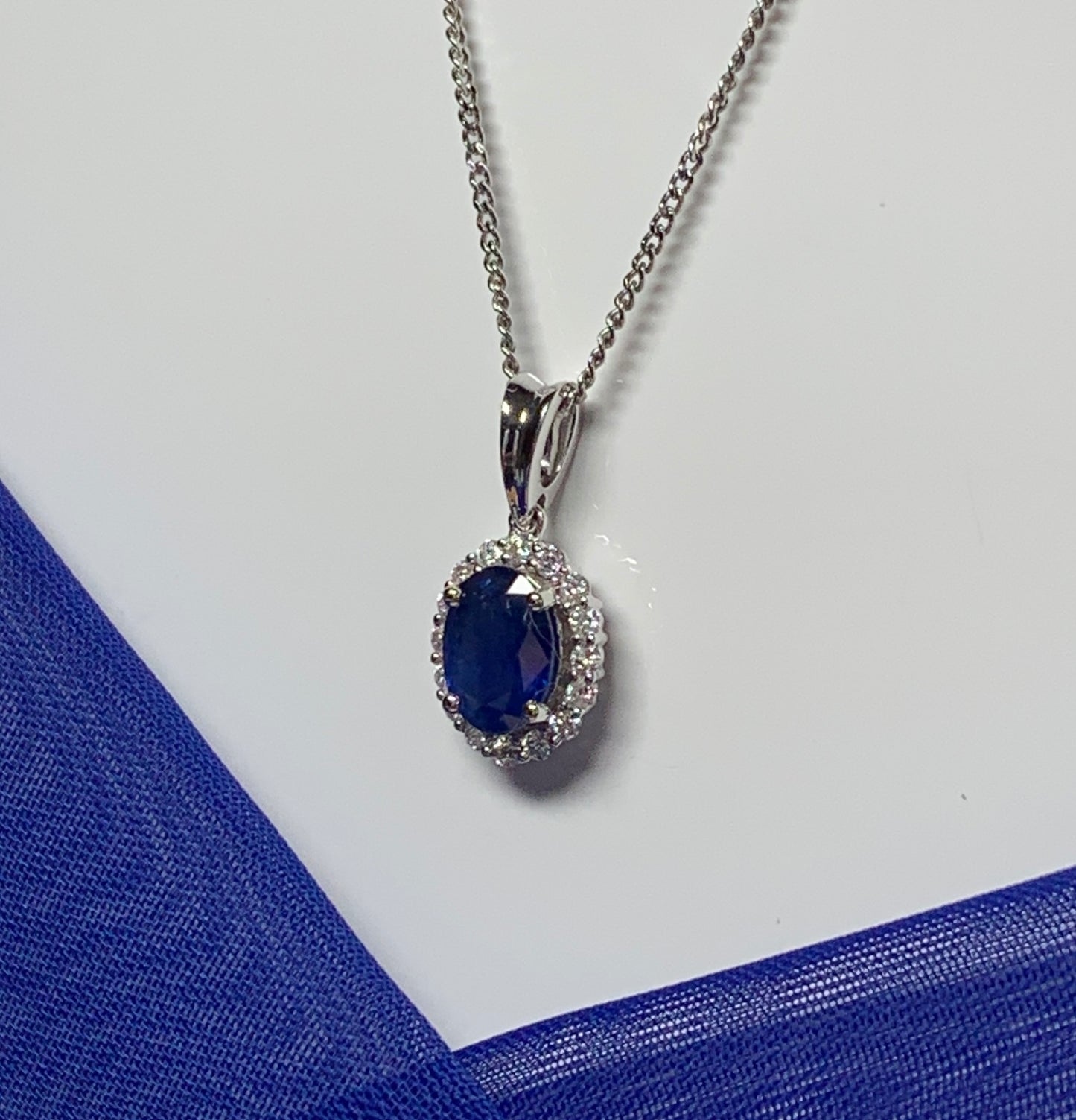 Real blue sapphire and diamond white gold cluster necklace oval pendant