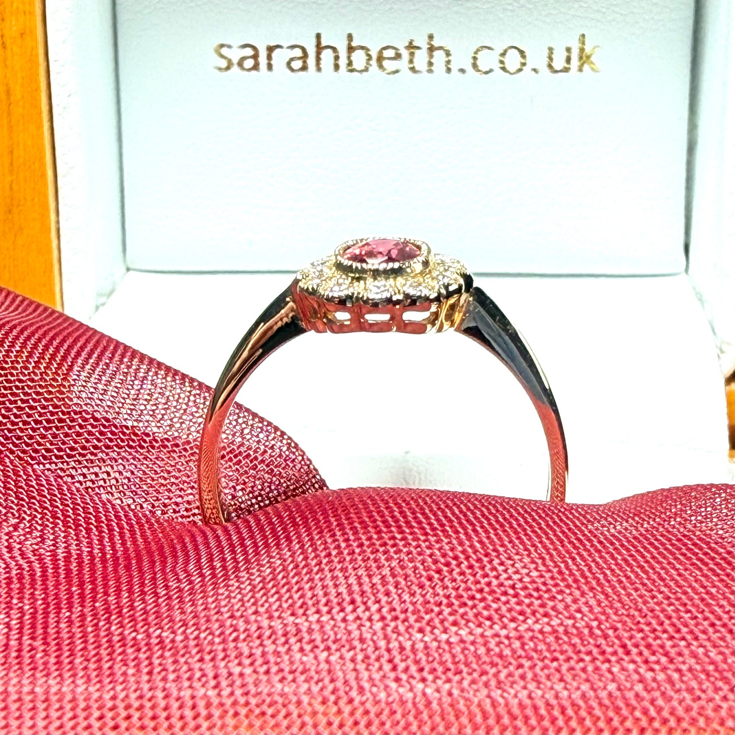 Oval shaped red real ruby and real diamond yellow gold cluster ring