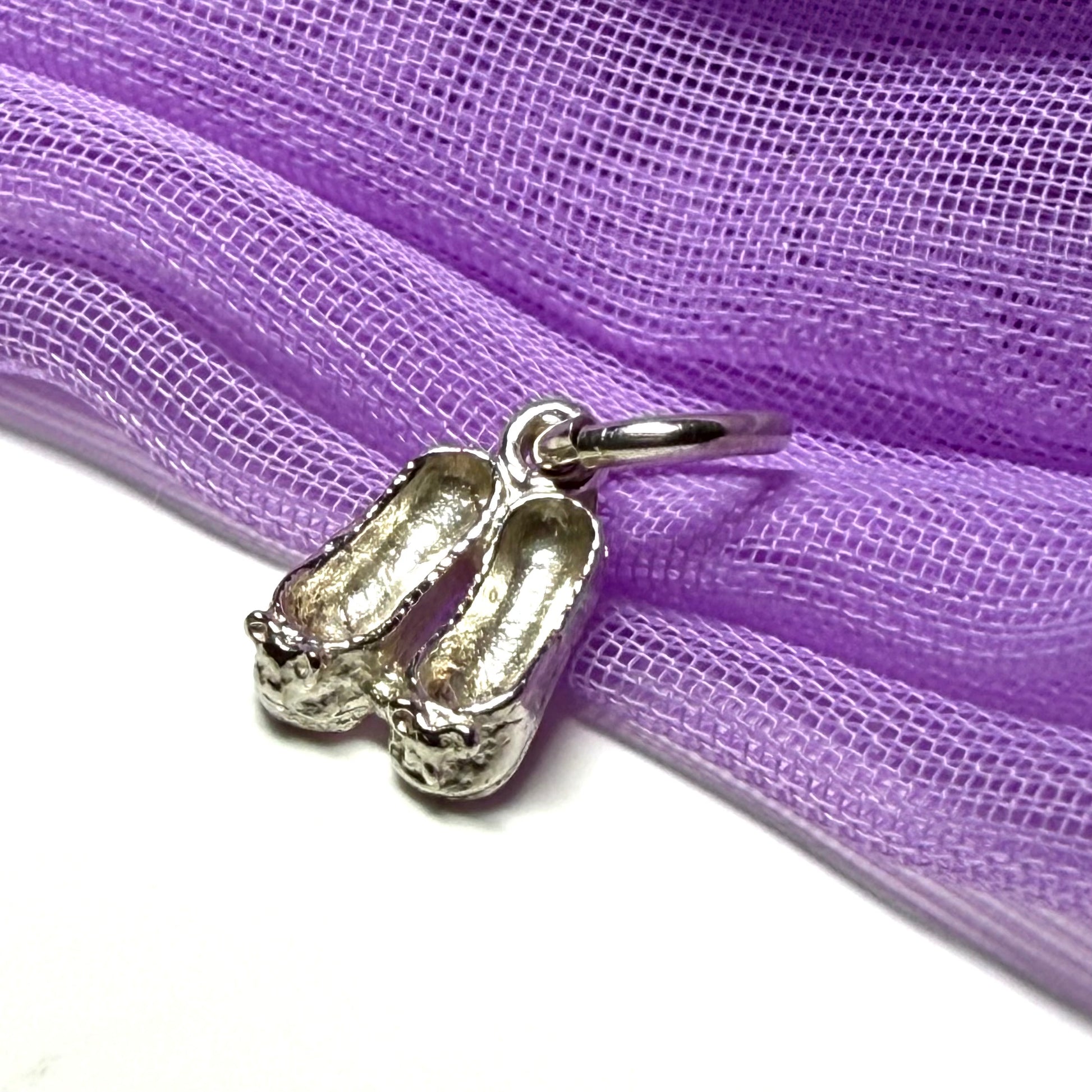 Small ballerina slippers shaped sterling silver charm