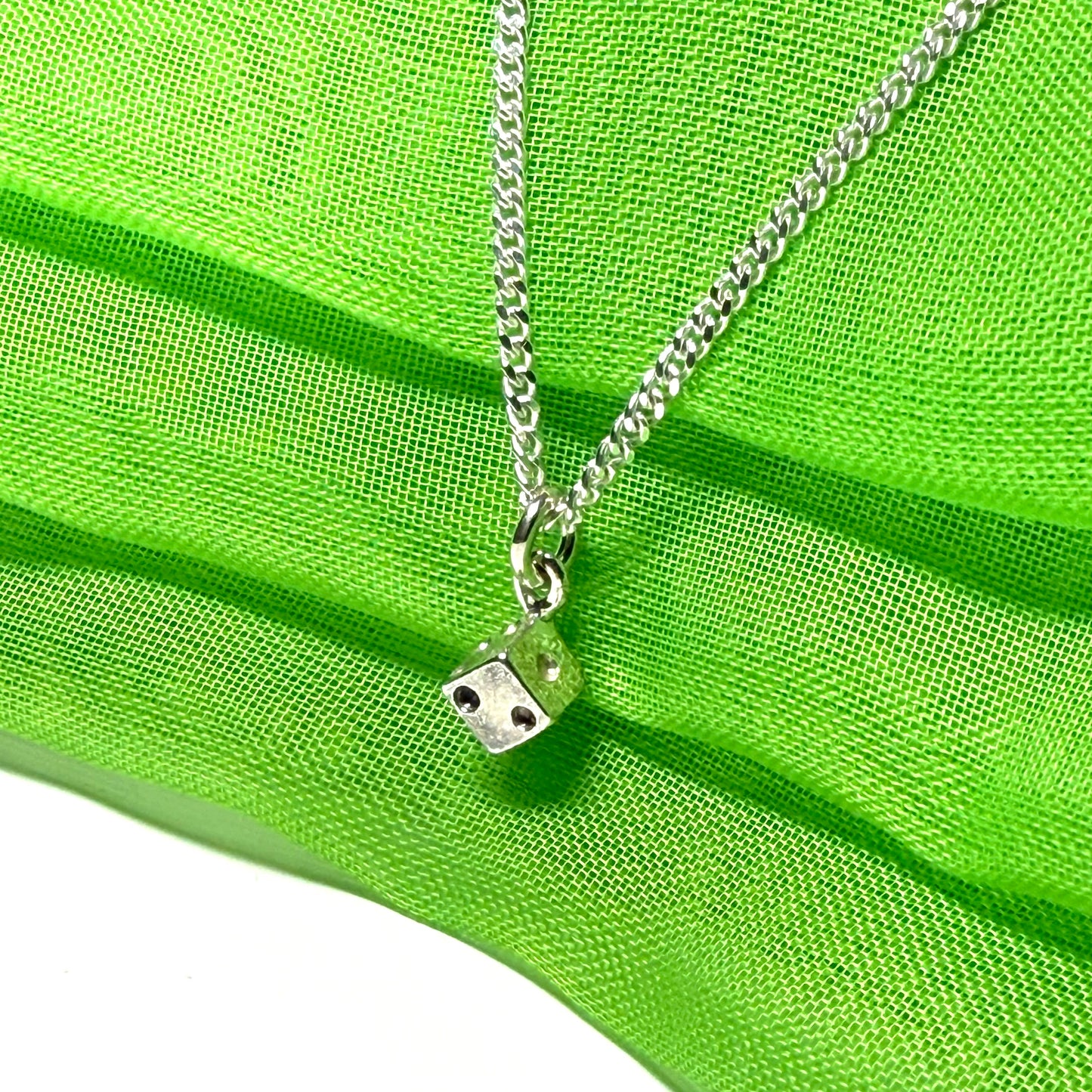 Small dice shaped sterling silver necklace with a chain included