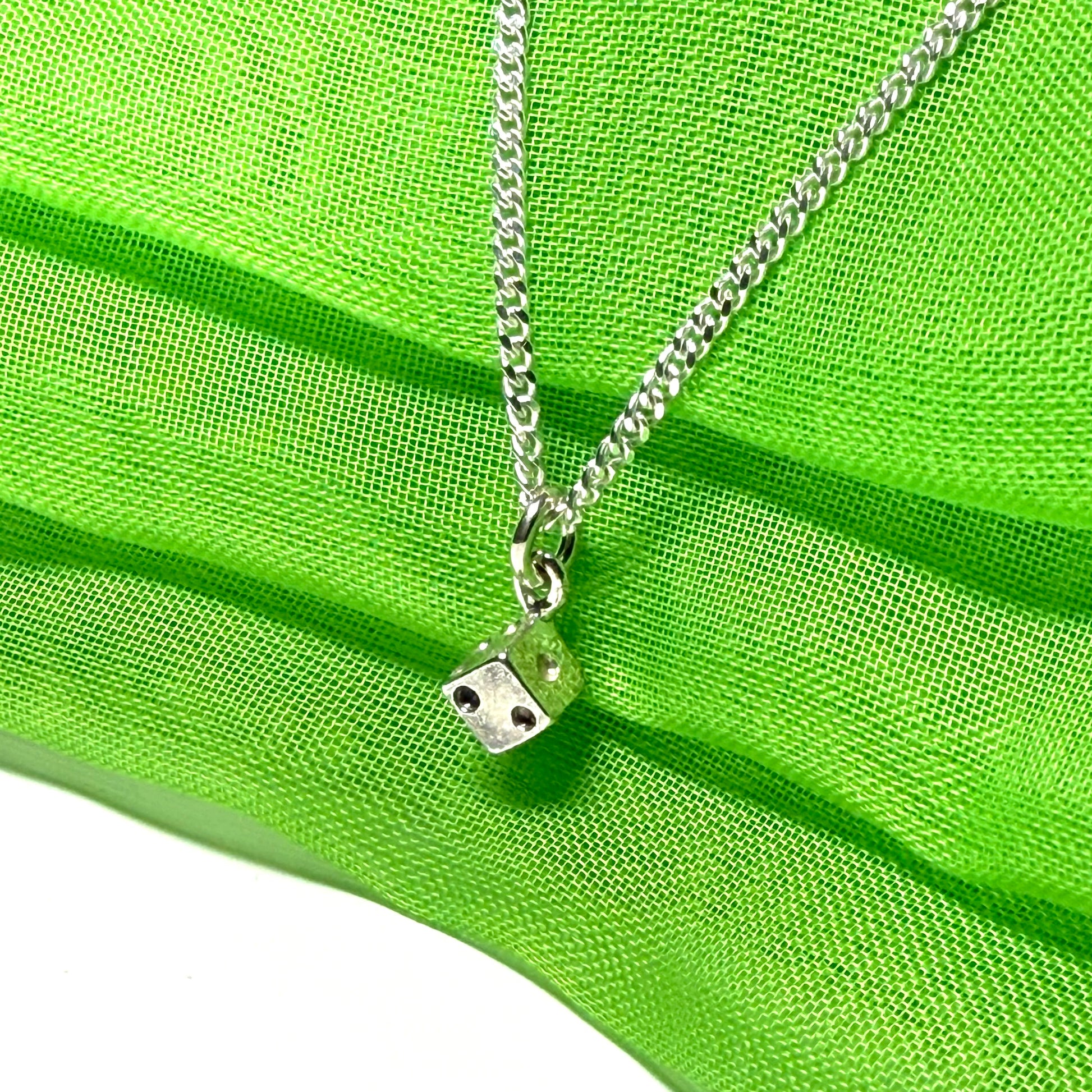 Small dice shaped sterling silver necklace with a chain included