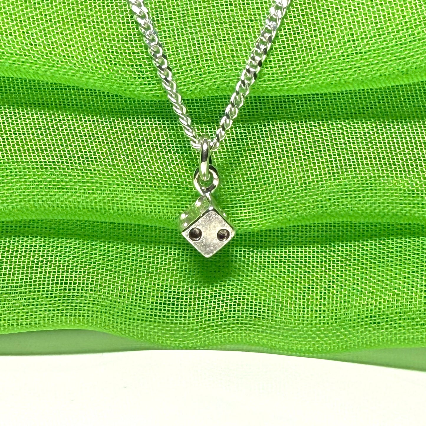 Small dice shaped sterling silver necklace with a chain included