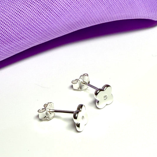 Small diamond set sterling silver daisy shaped stud earrings