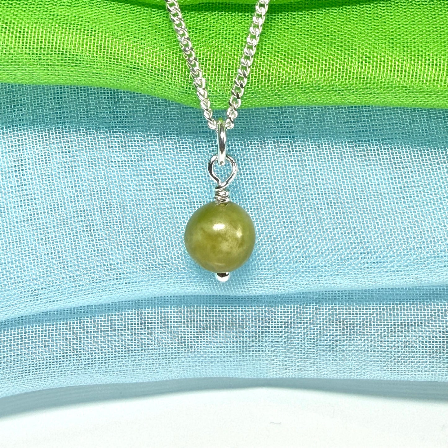 A small real green gypsum necklace ball shaped, a really gorgeous round pendant