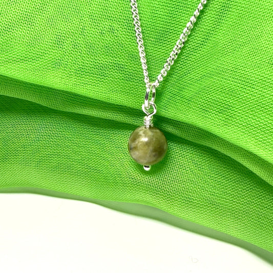 A small real green gypsum round necklace ball shaped, a traditional pendant