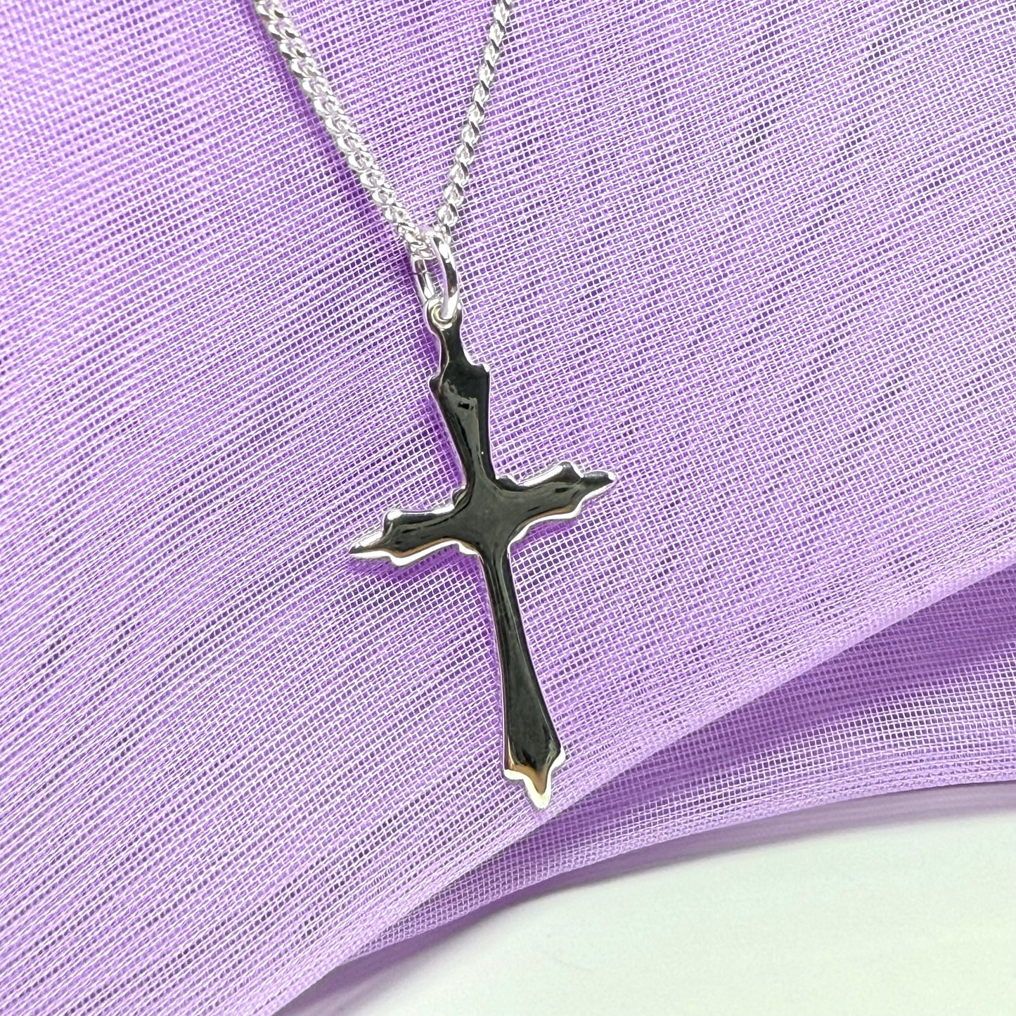A solid fancy shaped sterling silver cross necklace pendant with a chain included