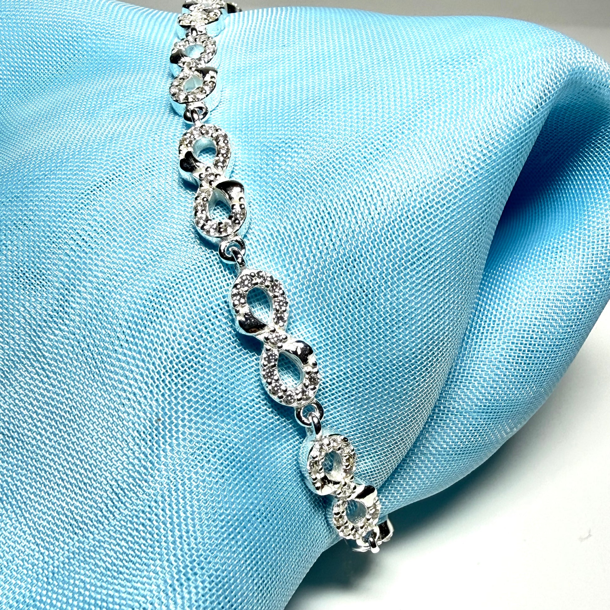 Sparkling infinity style shaped cubic zirconia sterling silver bracelet