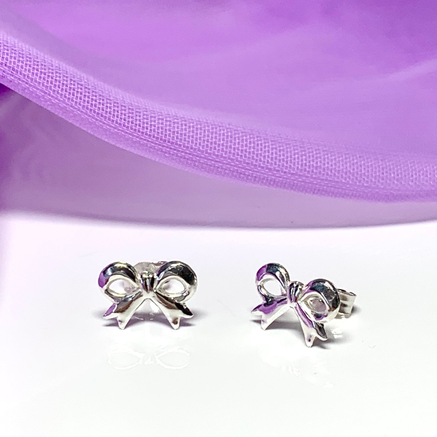 Sterling silver bow shaped stud earrings