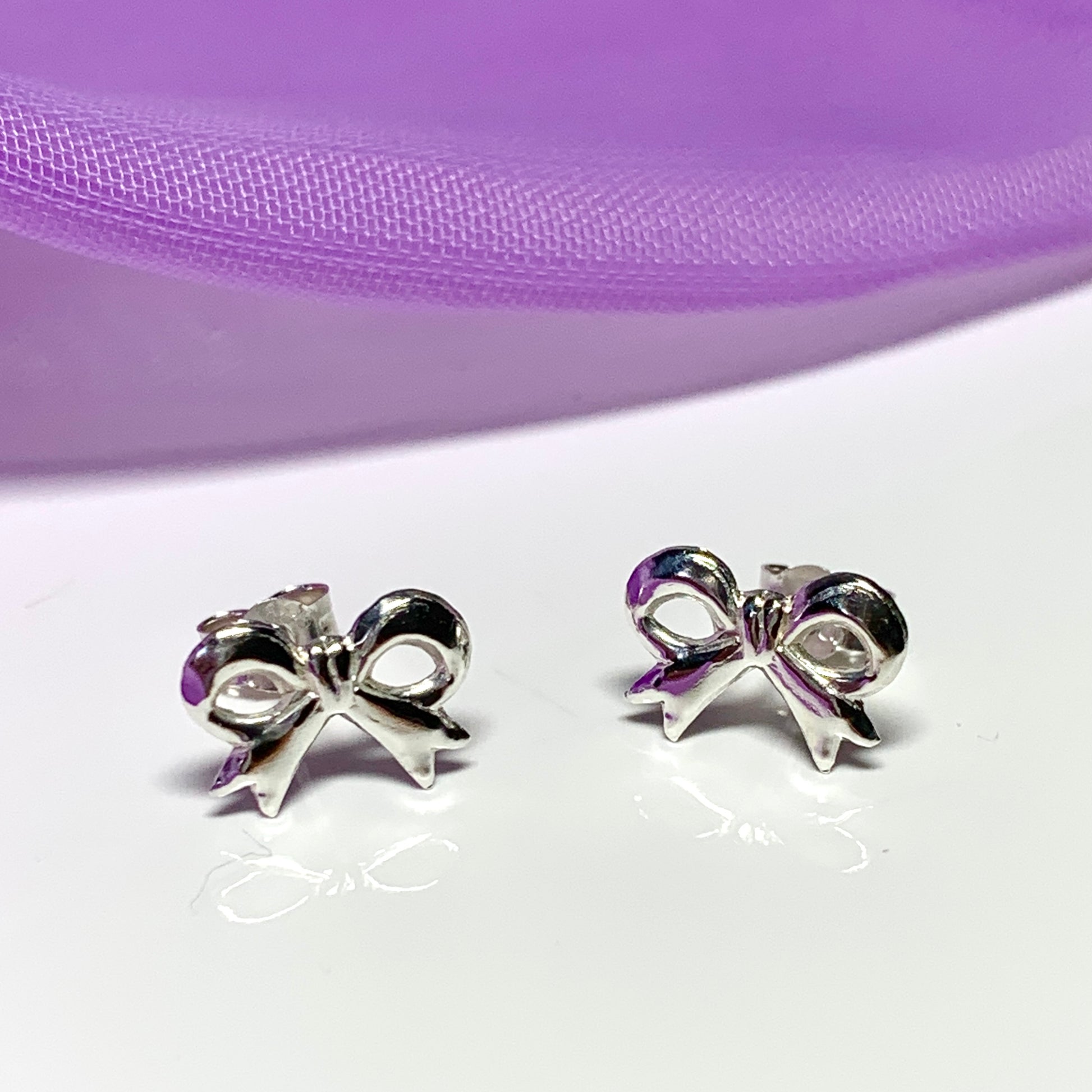 Sterling silver bow shaped stud earrings