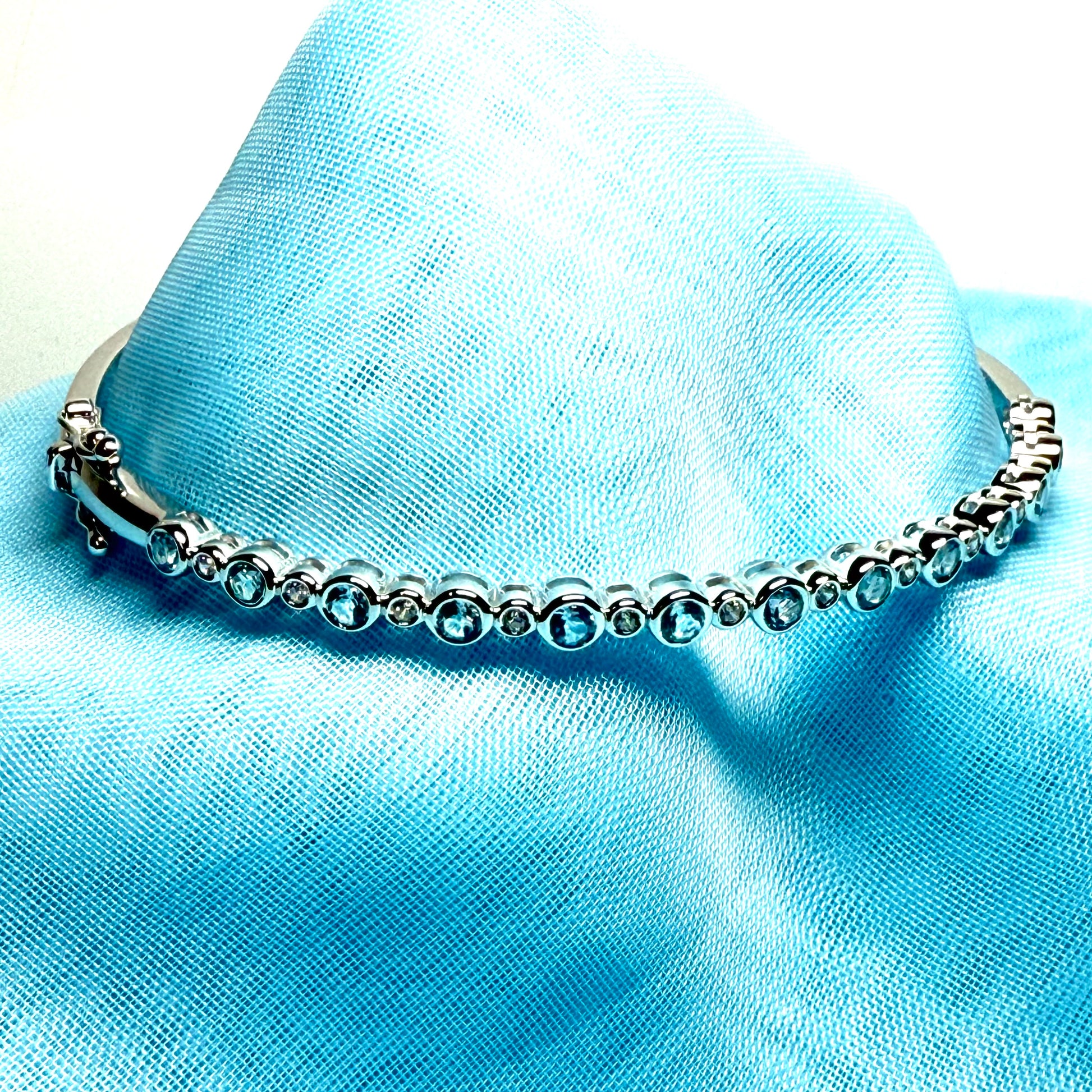 Sterling silver oval shaped real blue topaz cubic zirconia bangle