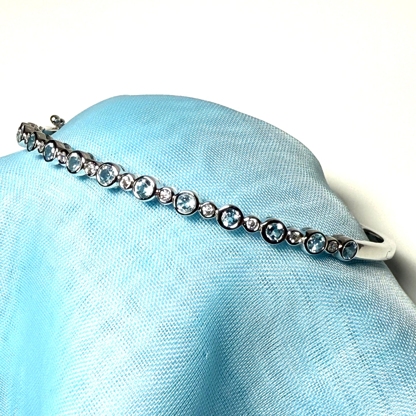 Sterling silver oval shaped real blue topaz cubic zirconia bangle