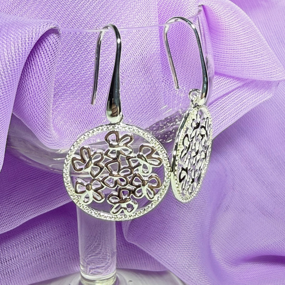 Sterling silver round shaped drop earrings with an open pierced design