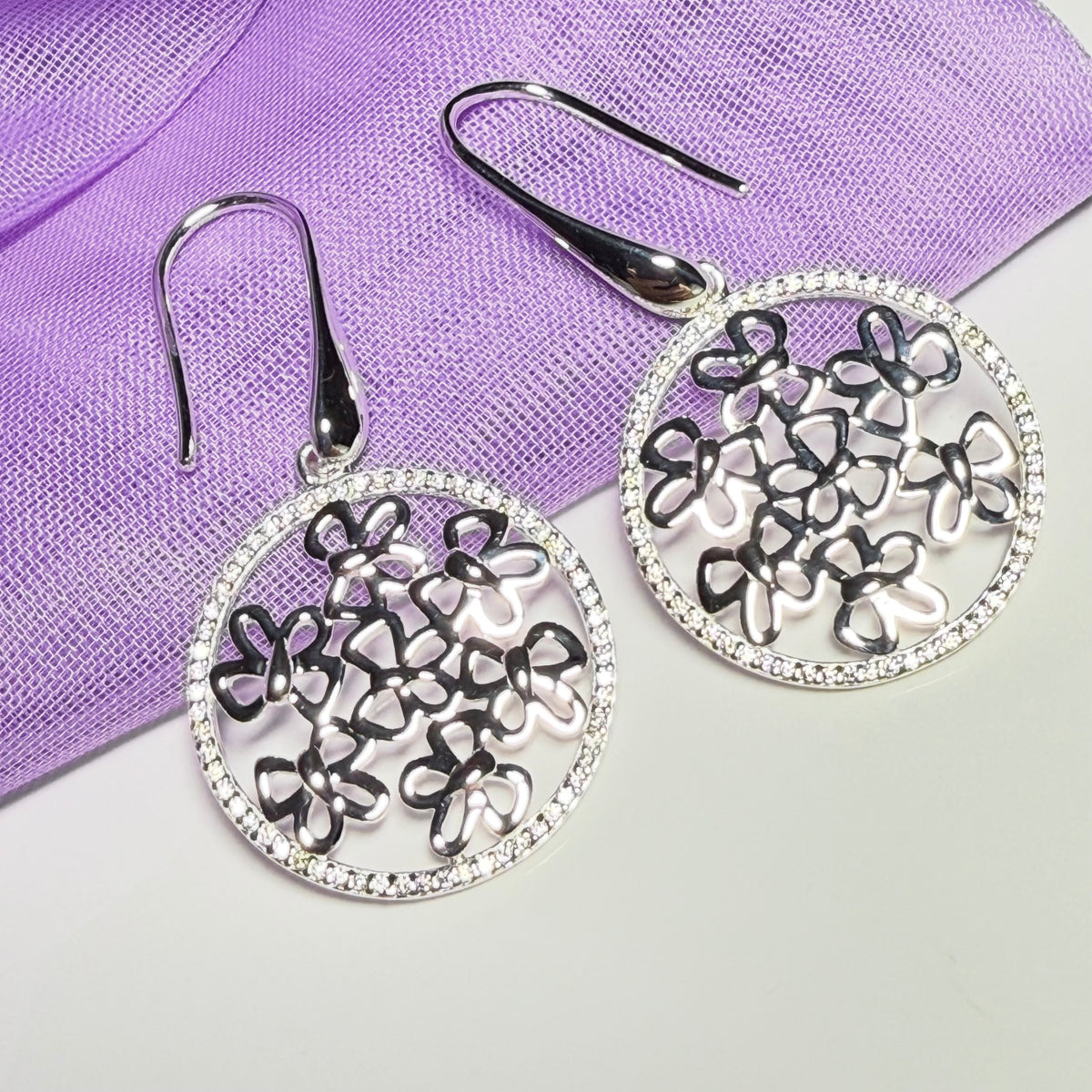 Sterling silver round shaped drop earrings with an open pierced design
