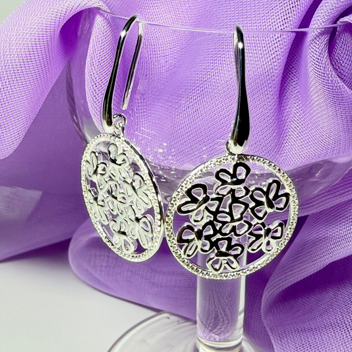 Sterling silver round shaped drop earrings with an open pierced design