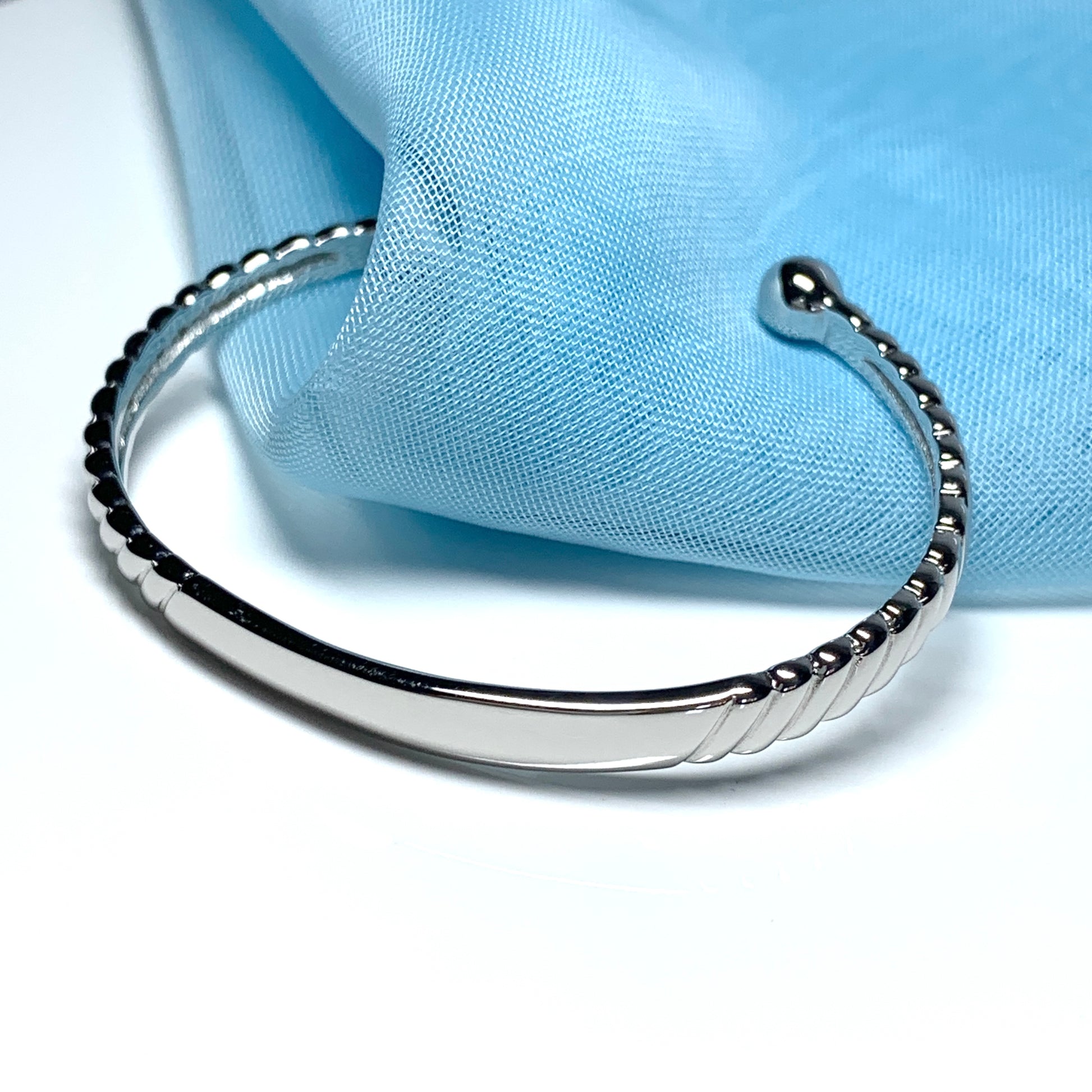 Sterling silver baby's solid torque bangle with a plain section for engraving