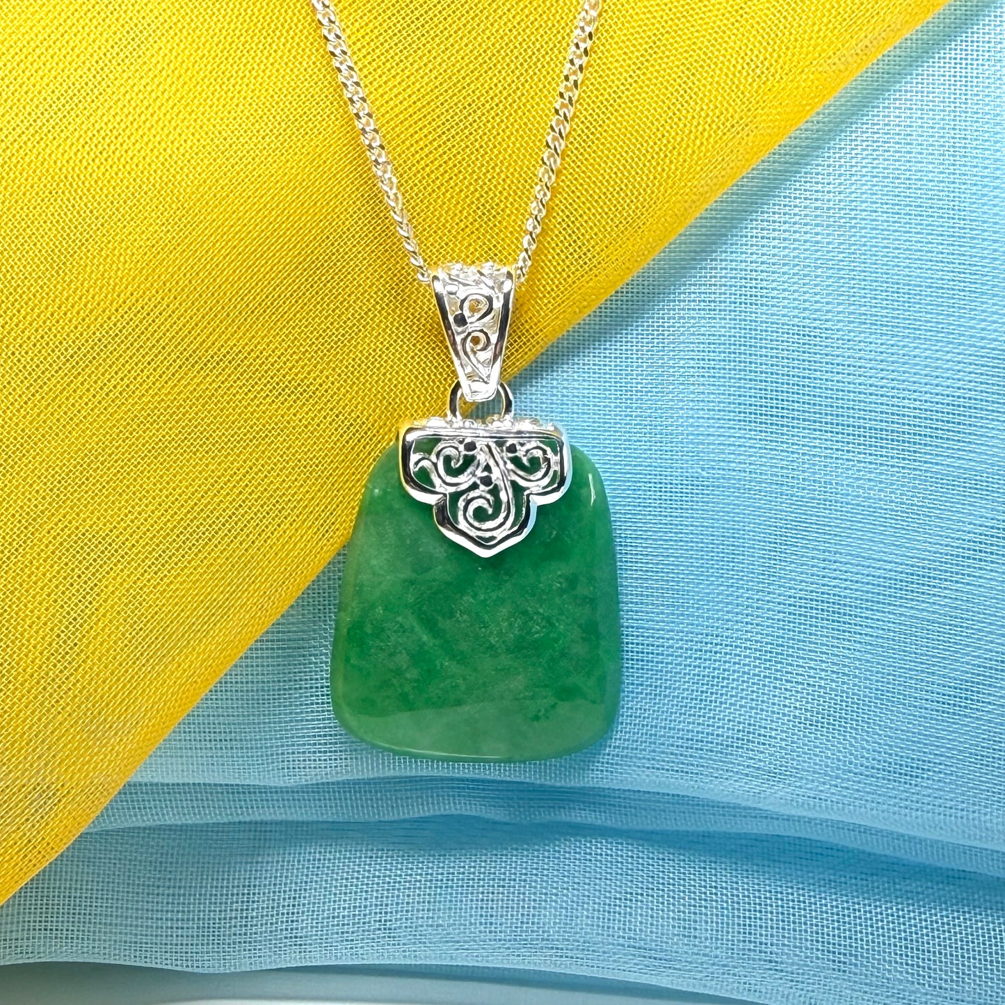 A stunning, a real green jade necklace large shaped with a patterned top pendant