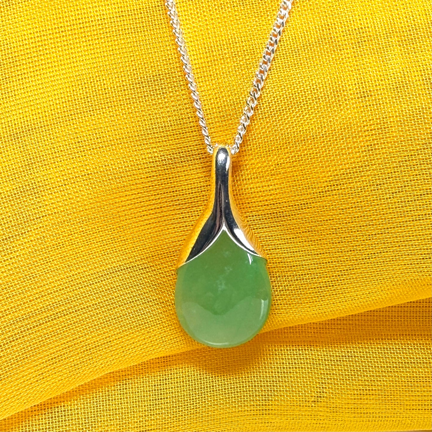 A stunning real green jade necklace in a teardrop, a timeless designed pendant and chain included