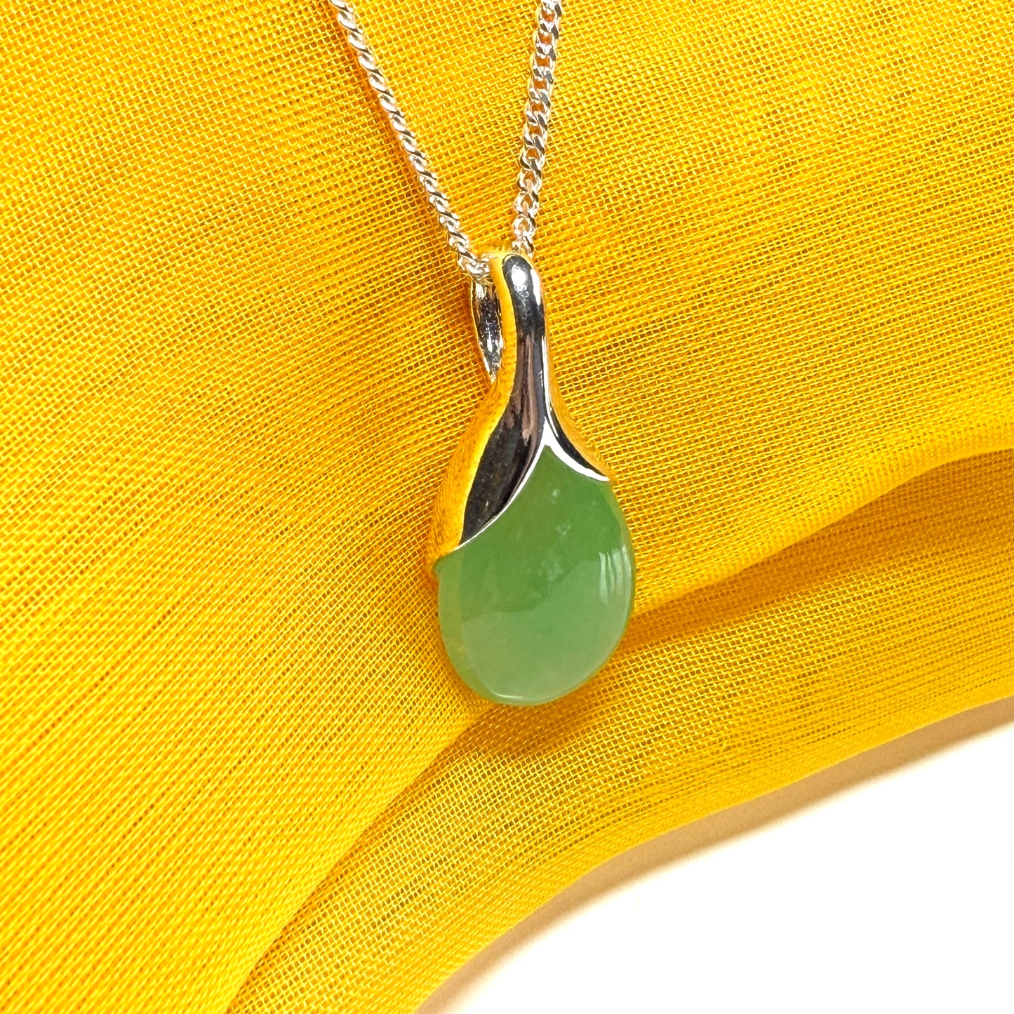 A stunning real green jade necklace in a teardrop, a timeless designed pendant and chain included