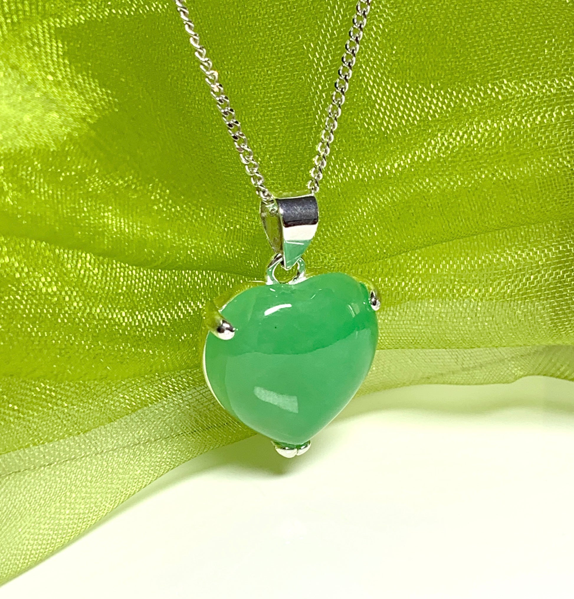 A really stunning real green jade necklace heart shaped sterling silver pendant