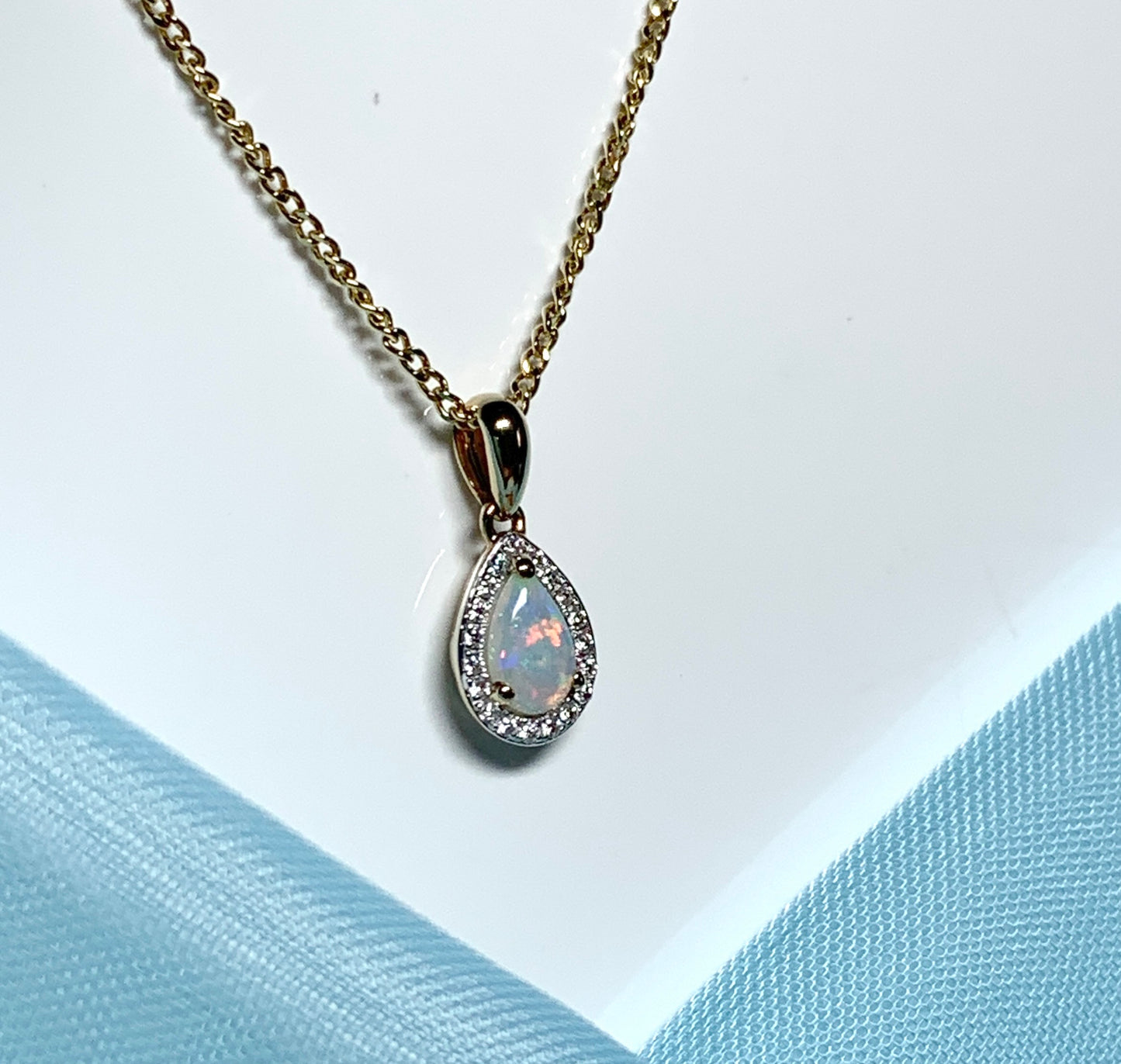 Teardrop shaped opal and diamond yellow gold cluster necklace