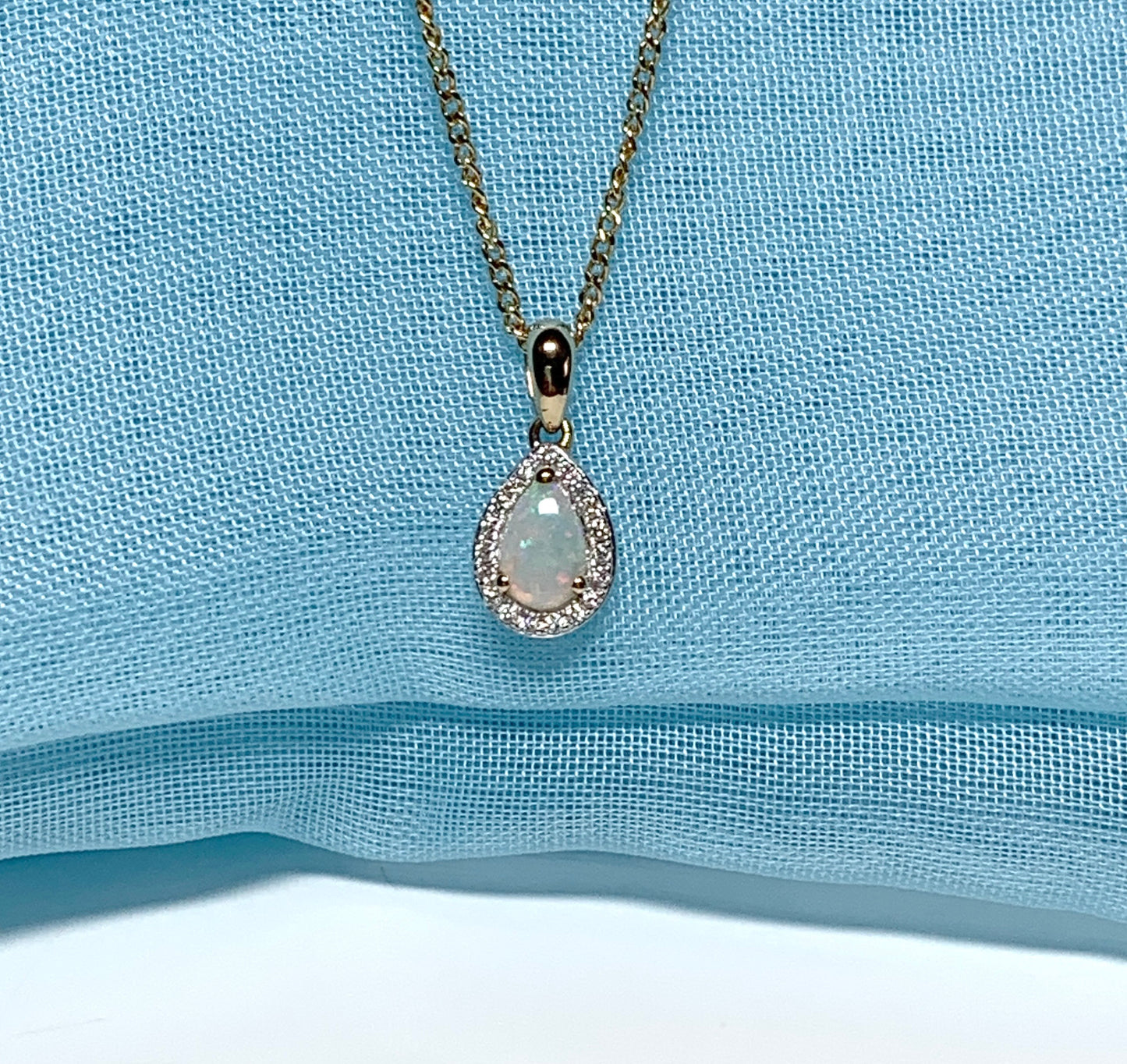 Teardrop shaped opal and diamond yellow gold cluster necklace