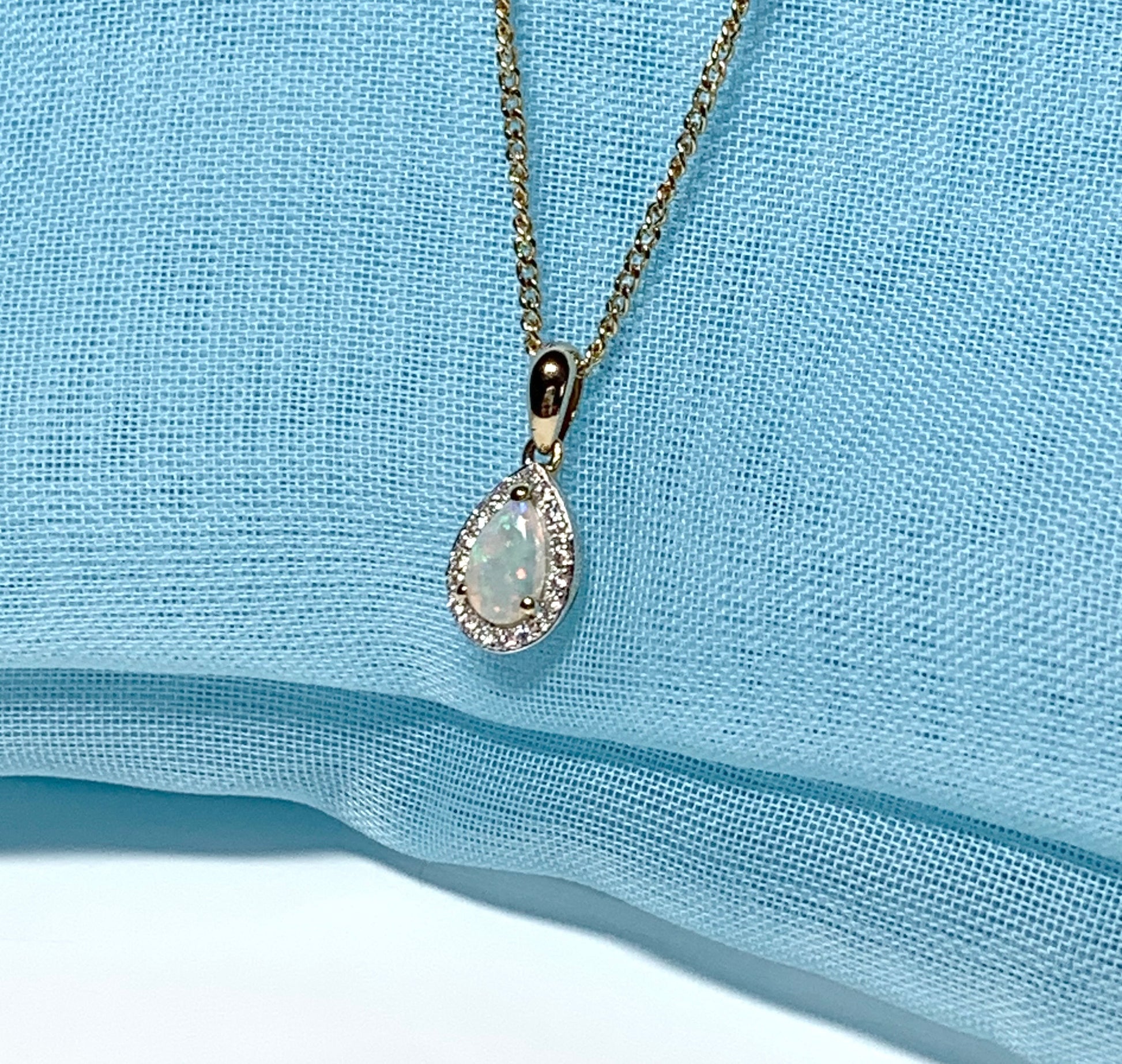 Teardrop shaped opal and diamond yellow gold cluster necklace